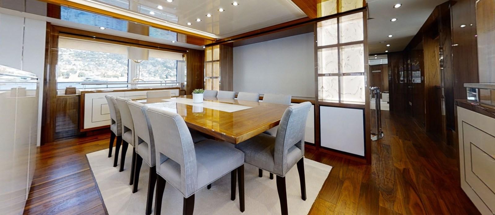 a large room with a table and chairs aboard ALADDIN Yacht for Sale