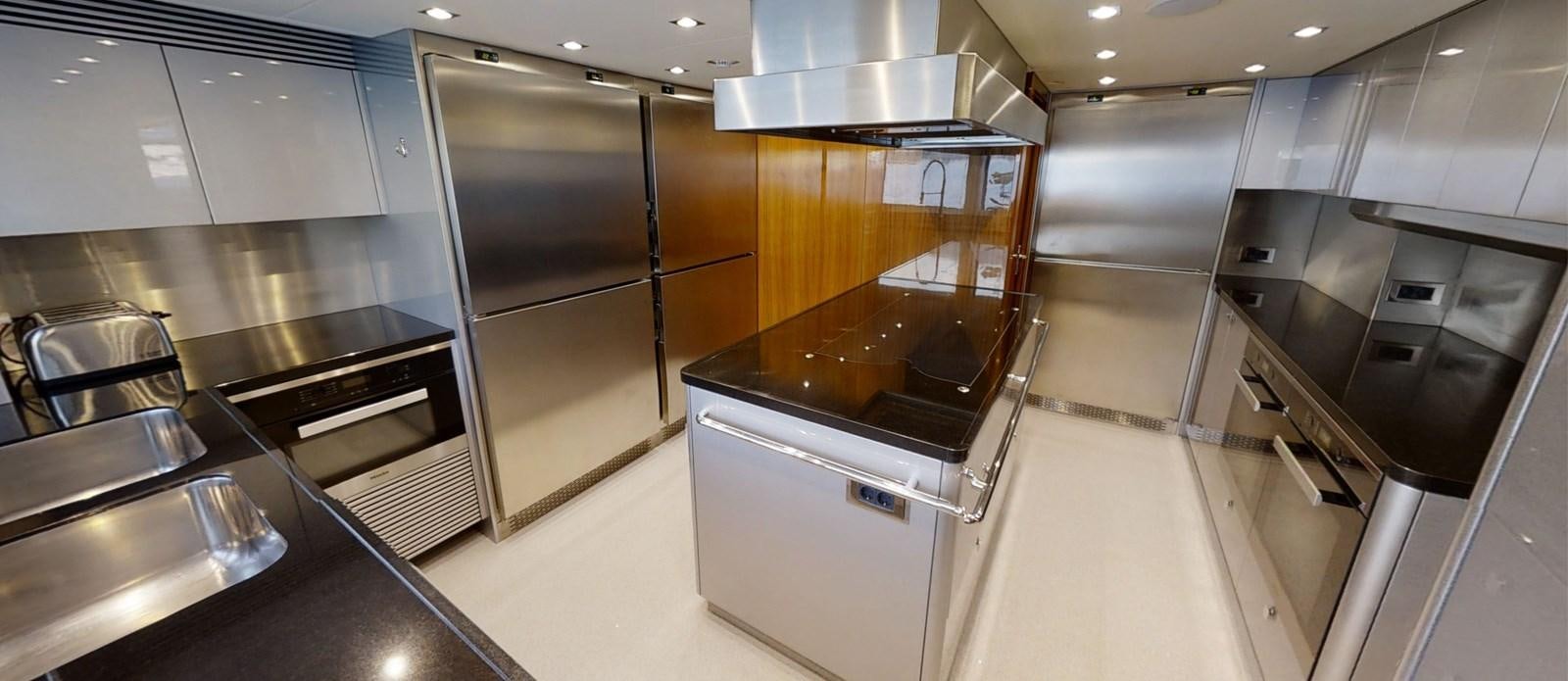 a kitchen with stainless steel appliances aboard ALADDIN Yacht for Sale