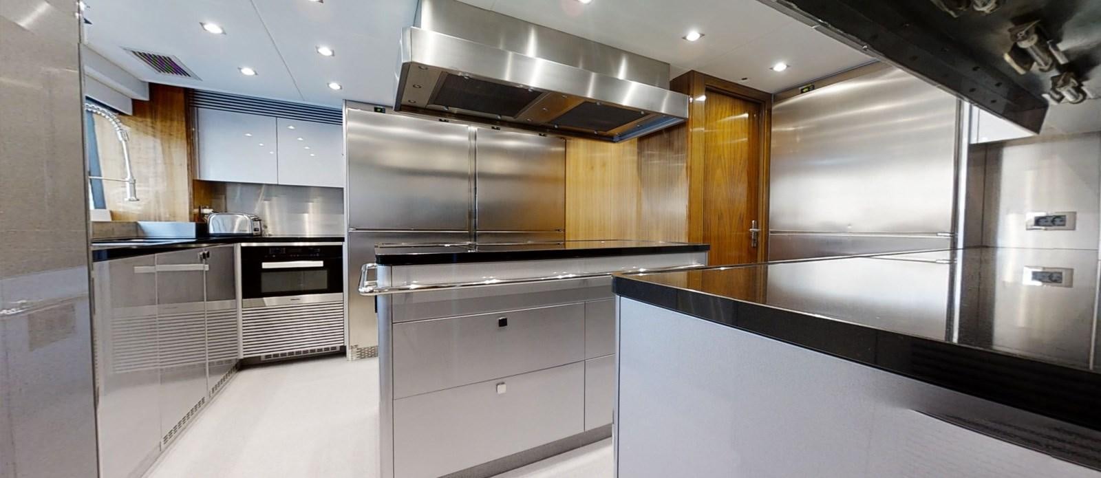 a kitchen with a large stainless steel oven and cabinets aboard ALADDIN Yacht for Sale
