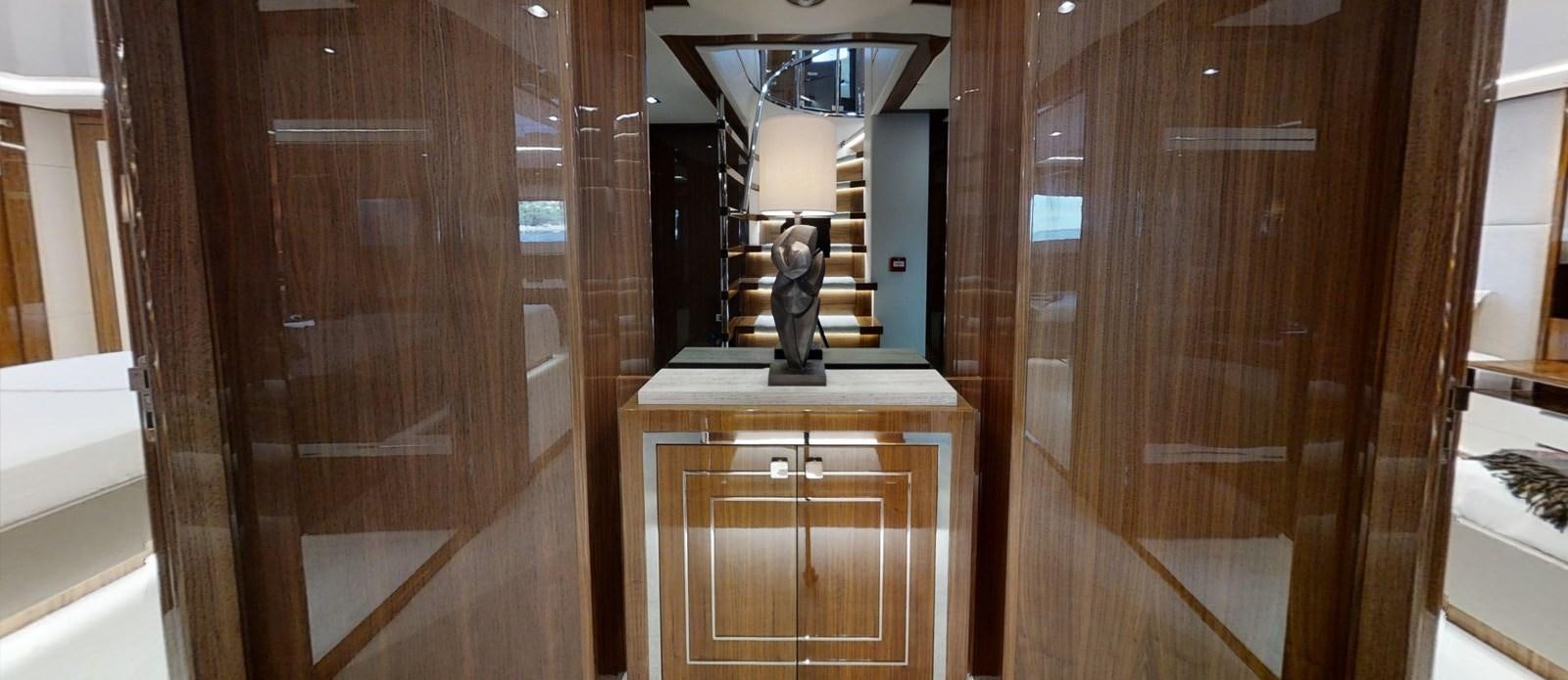 a wood cabinet with a lamp on top of it aboard ALADDIN Yacht for Sale