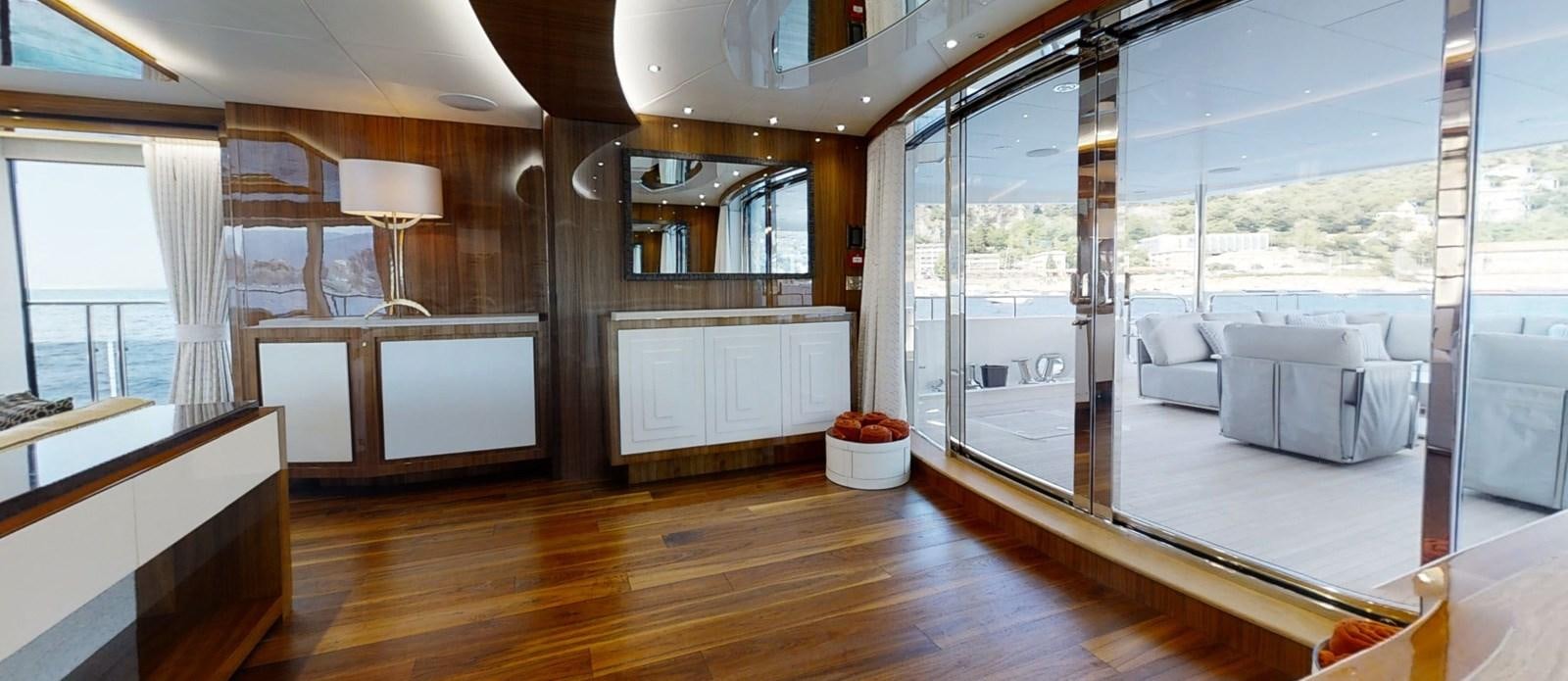 a room with a wood floor and a large window aboard ALADDIN Yacht for Sale