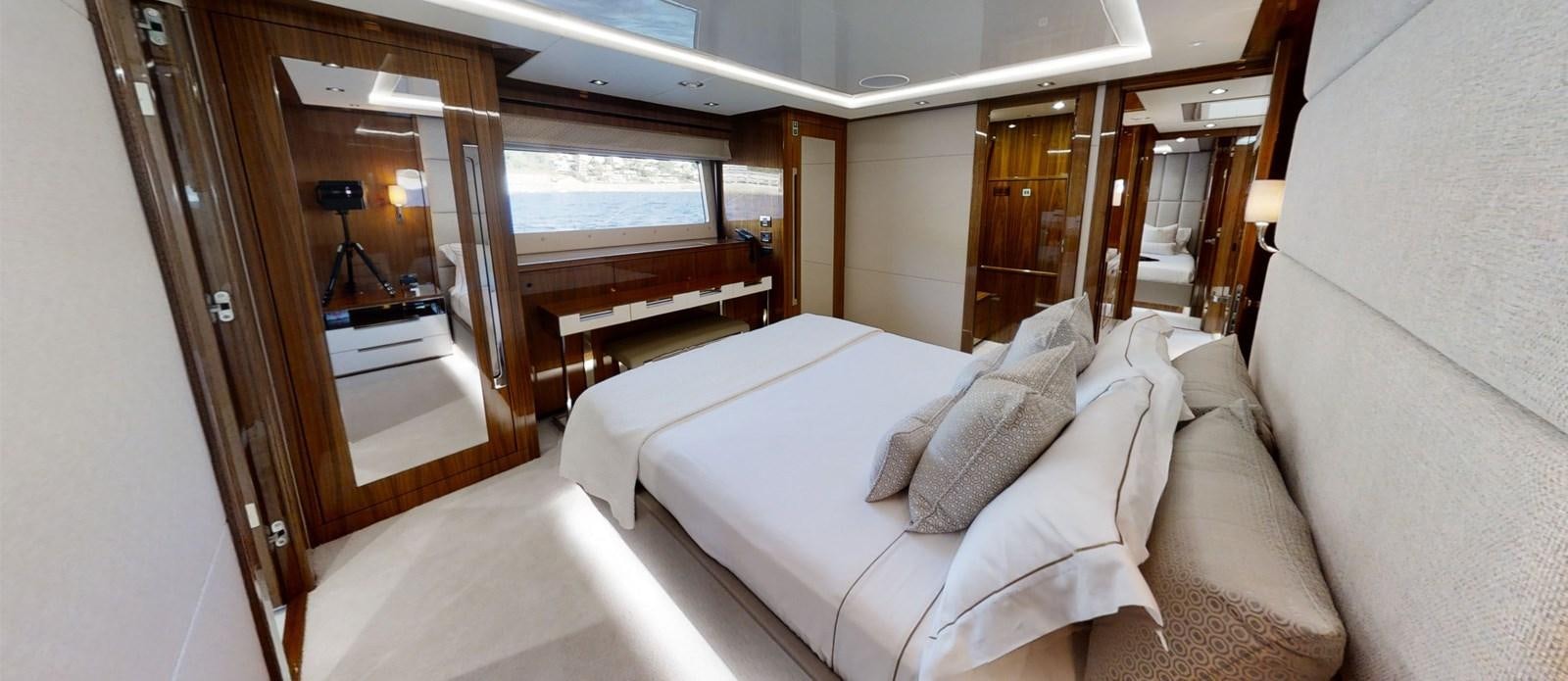 a room with a bed and a mirror aboard ALADDIN Yacht for Sale