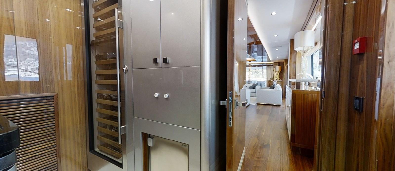 a room with a wood door and a wood cabinet with a white couch aboard ALADDIN Yacht for Sale