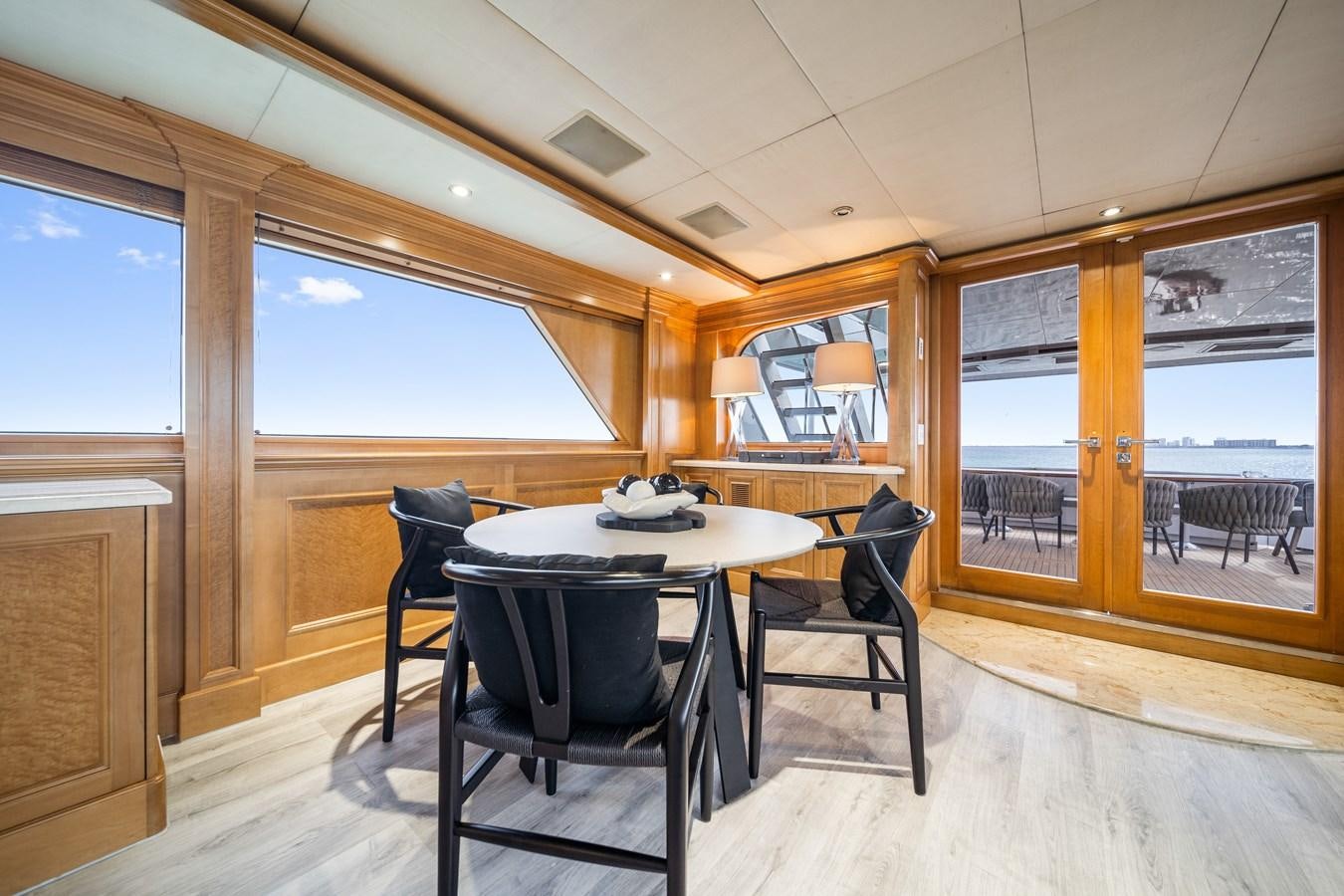 a room with a table and chairs aboard OCEAN DRIVE Yacht for Sale