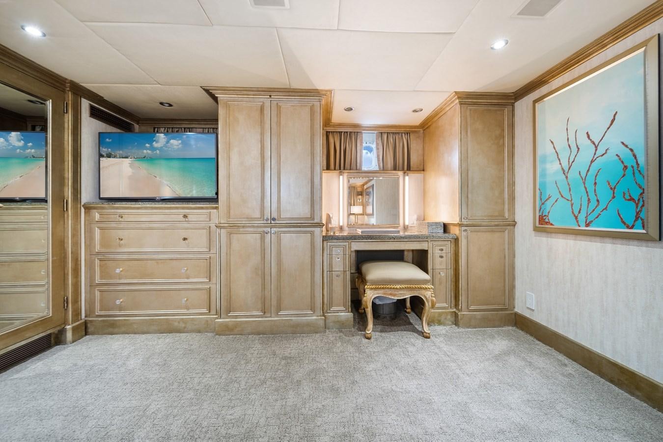 a room with a wood cabinet and a television in it aboard OCEAN DRIVE Yacht for Sale