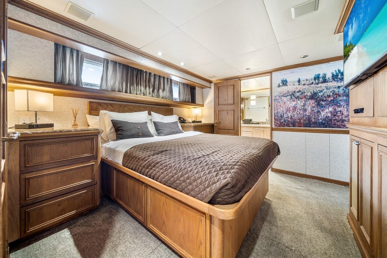 a bedroom with a bed and a dresser aboard OCEAN DRIVE Yacht for Sale
