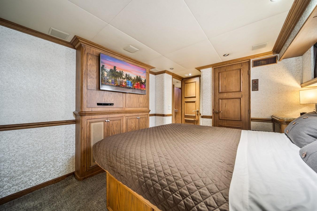 a bedroom with a bed and a television aboard OCEAN DRIVE Yacht for Sale