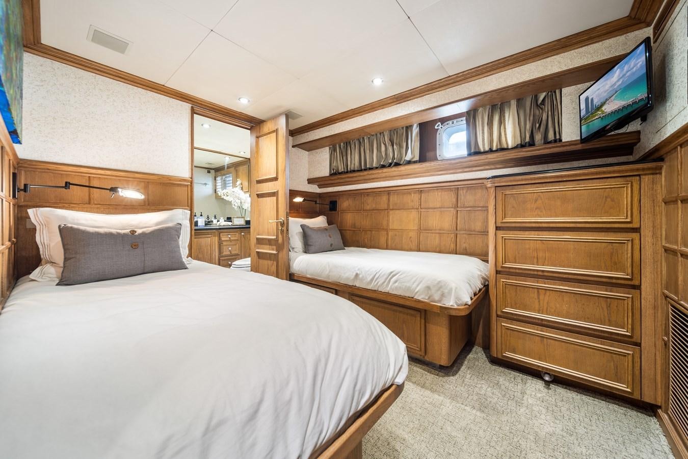 a room with a bed and a television aboard OCEAN DRIVE Yacht for Sale