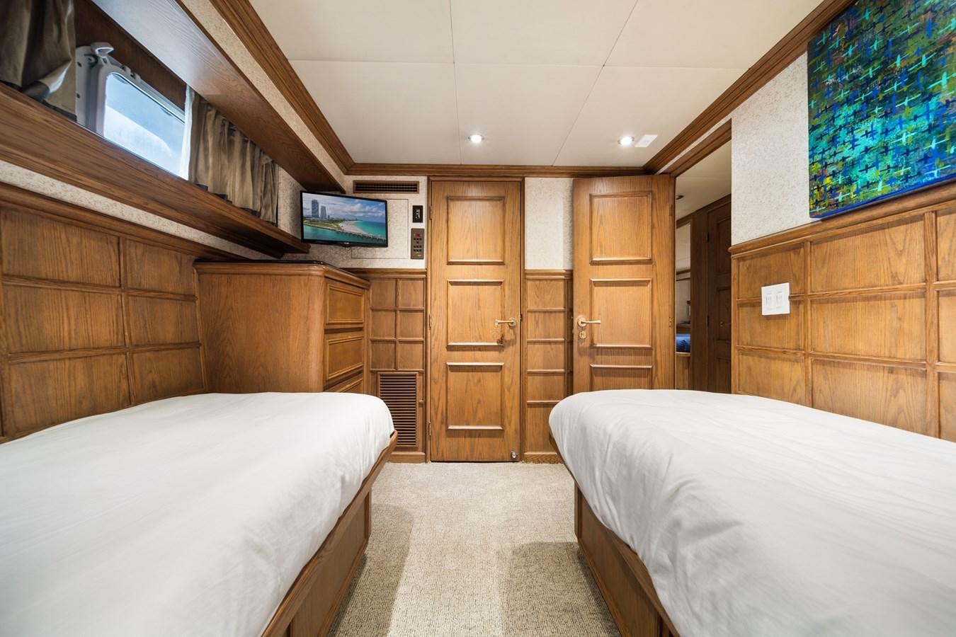 a room with wooden cabinets and a bed aboard OCEAN DRIVE Yacht for Sale