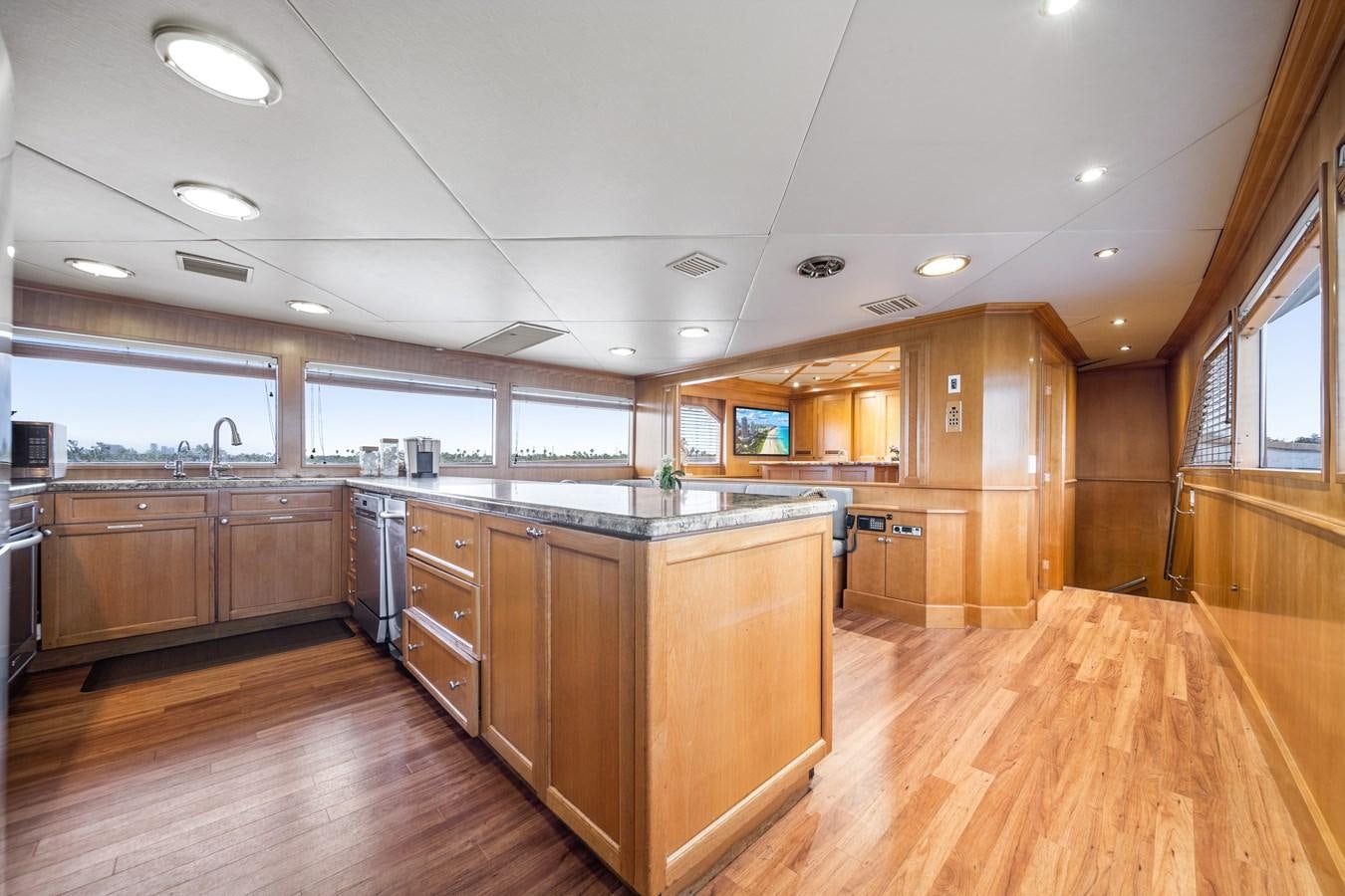 a large kitchen with wooden cabinets aboard OCEAN DRIVE Yacht for Sale