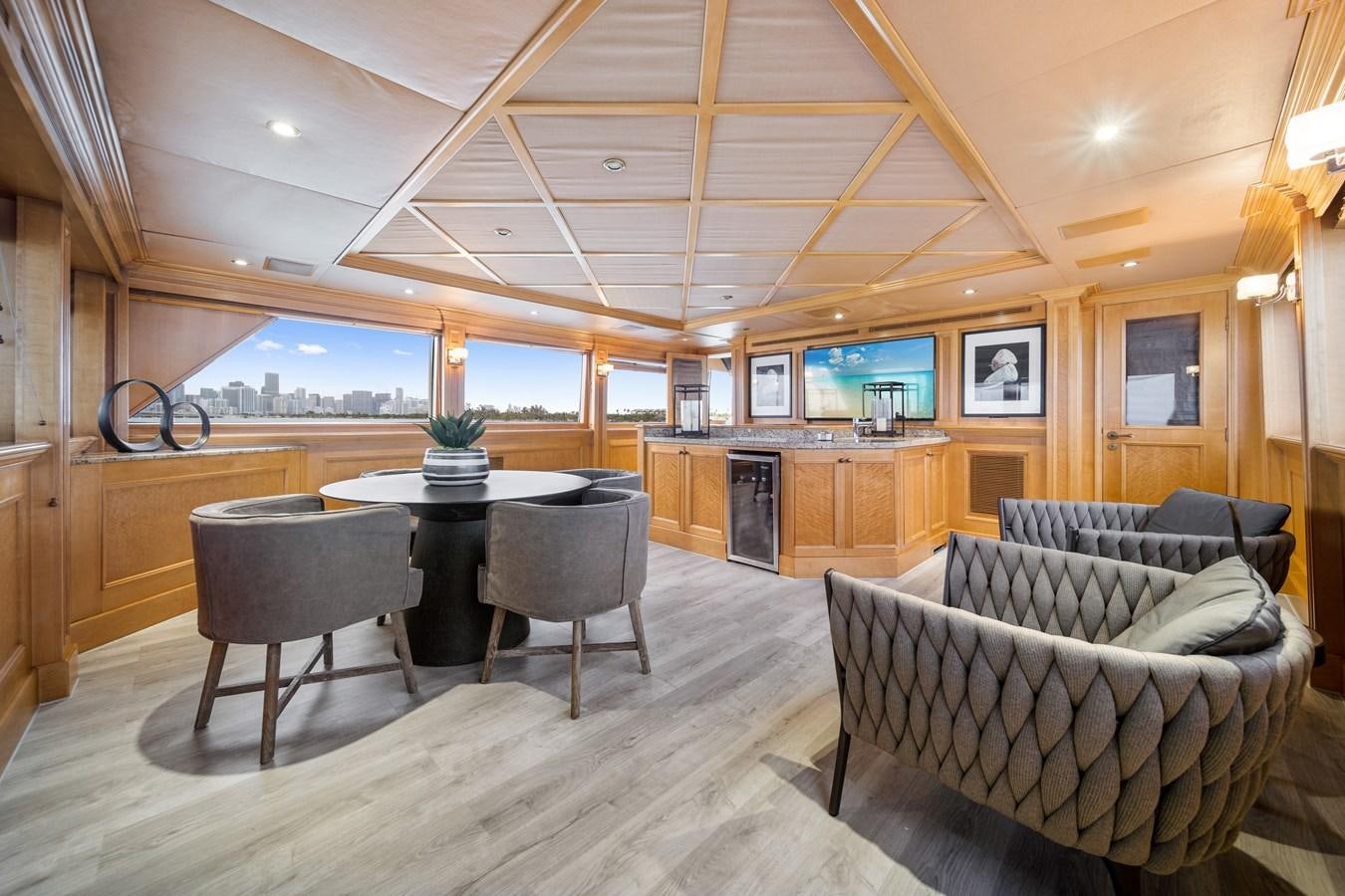 a living room with a table and chairs aboard OCEAN DRIVE Yacht for Sale