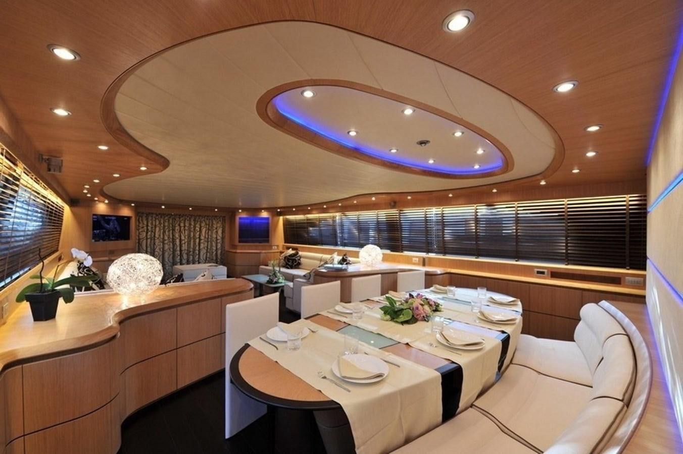 a room with tables and chairs aboard MAIORA 35 DP Yacht for Sale