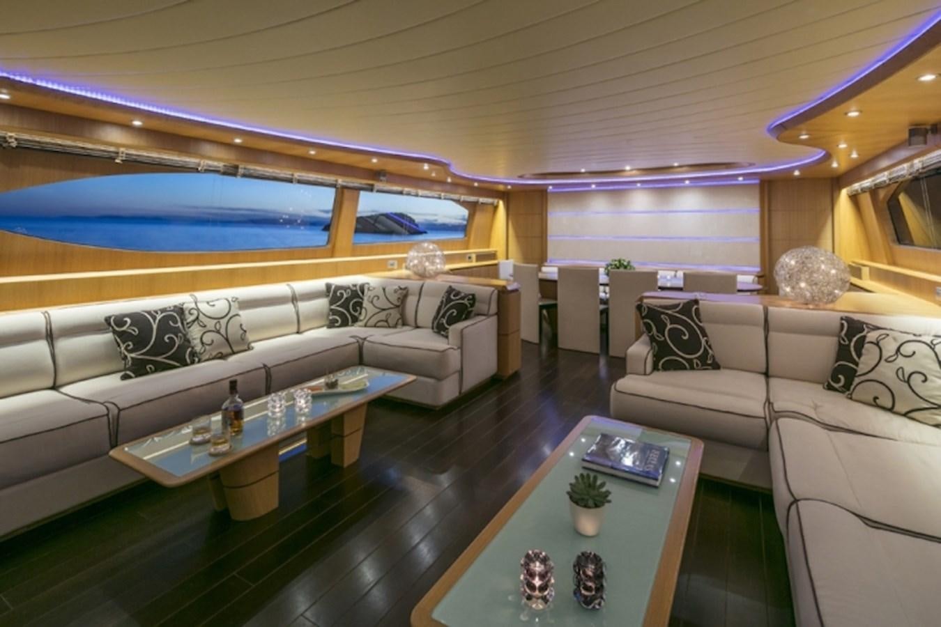 a living room with a large sofa and a table aboard MAIORA 35 DP Yacht for Sale