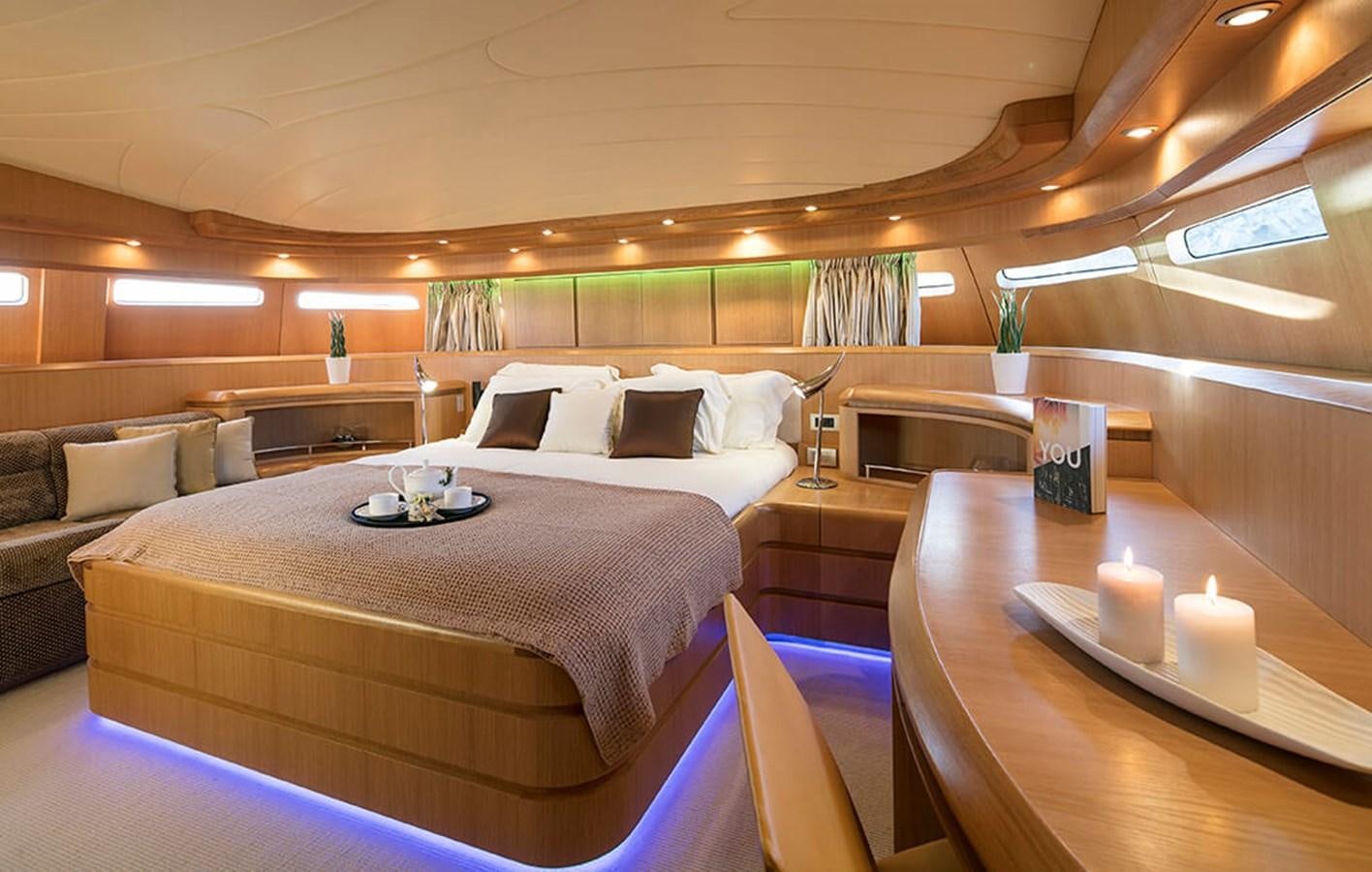 a room with a bed and a couch aboard MAIORA 35 DP Yacht for Sale