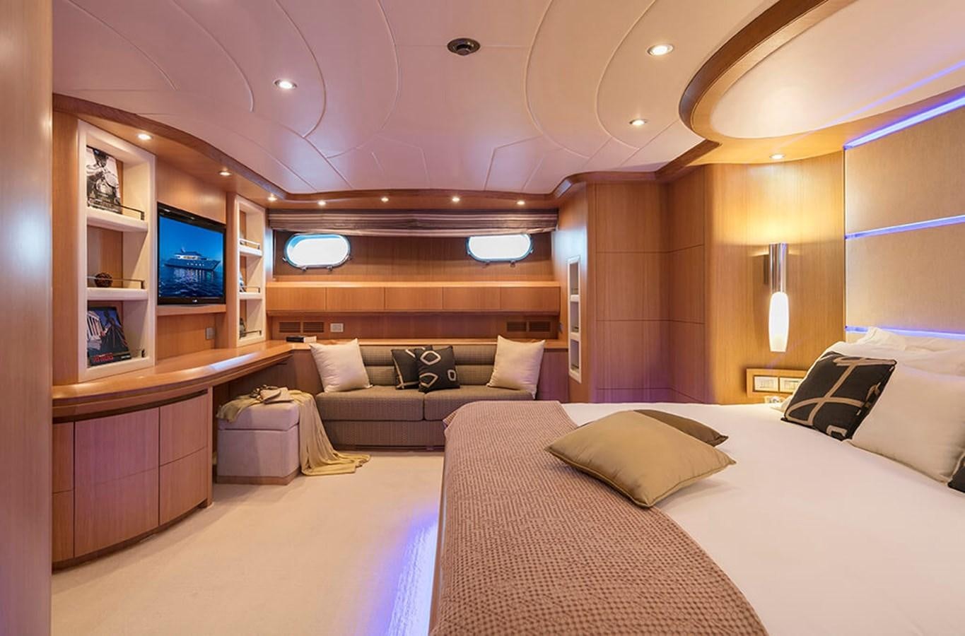 a room with a bed and a couch aboard MAIORA 35 DP Yacht for Sale