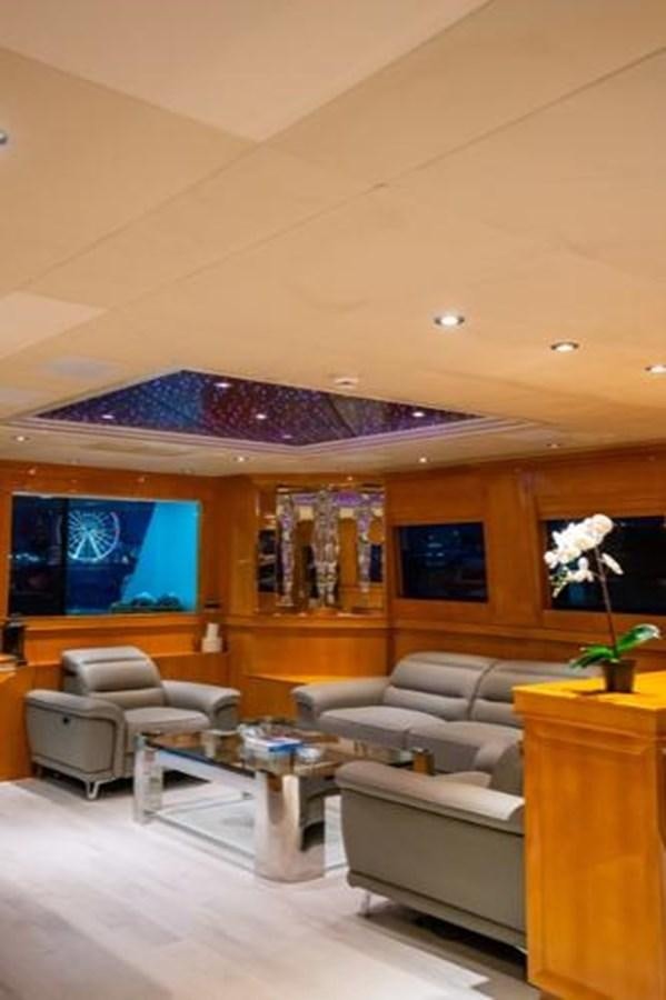 a living room with a large screen aboard 2000 116 BAGLIETTO Yacht for Sale