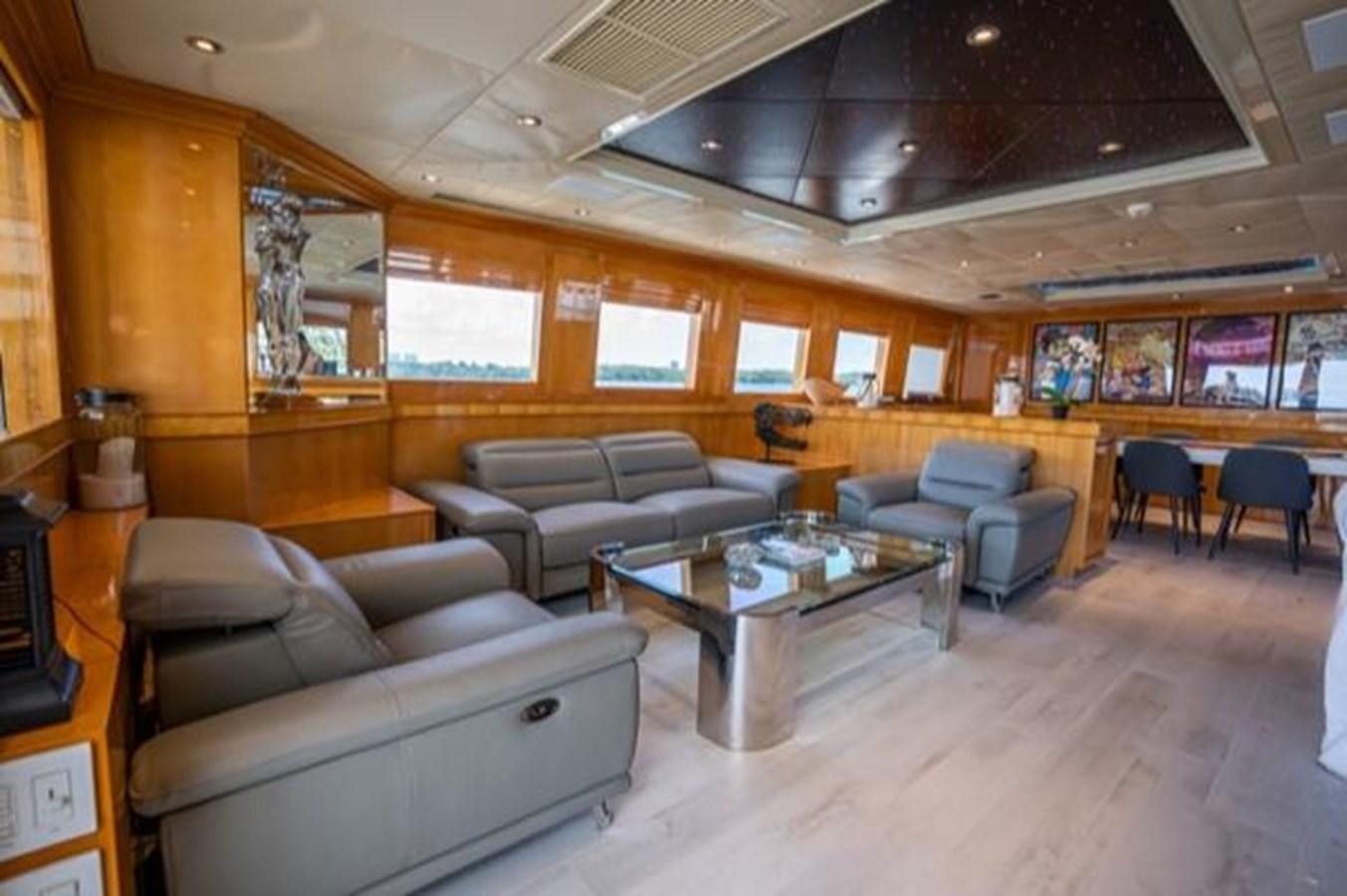 a living room with a couch and a coffee table aboard 2000 116 BAGLIETTO Yacht for Sale