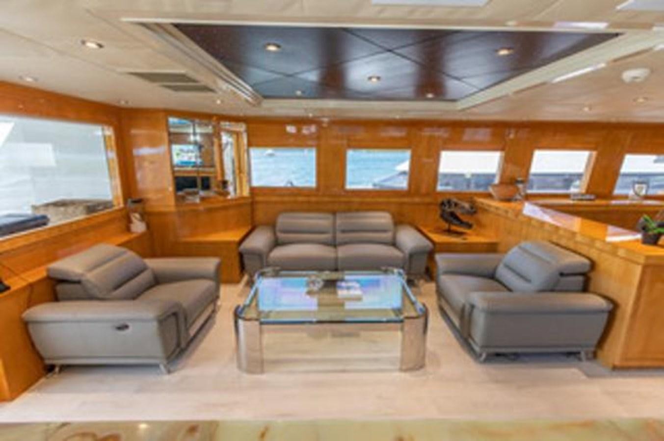 a living room with leather couches aboard 2000 116 BAGLIETTO Yacht for Sale