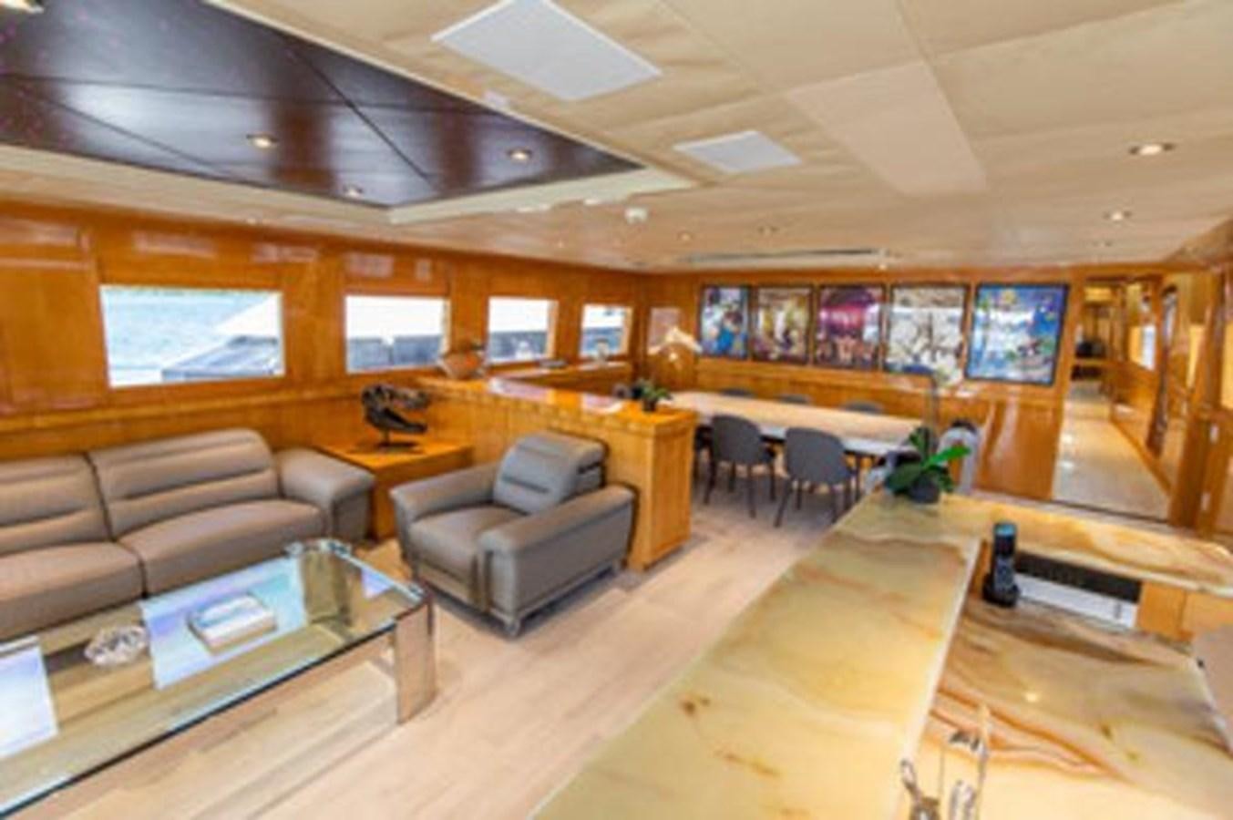 a room with a couch and a coffee table aboard 2000 116 BAGLIETTO Yacht for Sale