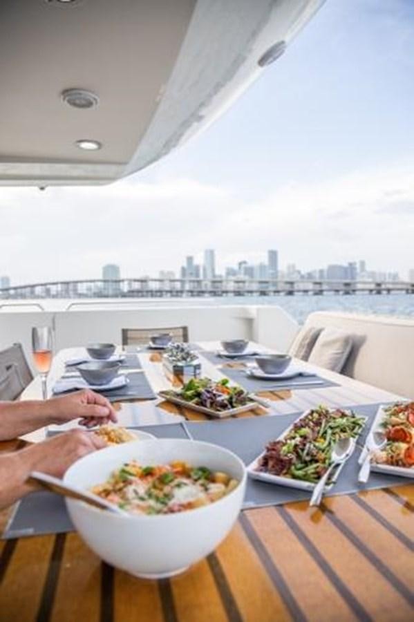 a table with food on it aboard 2000 116 BAGLIETTO Yacht for Sale