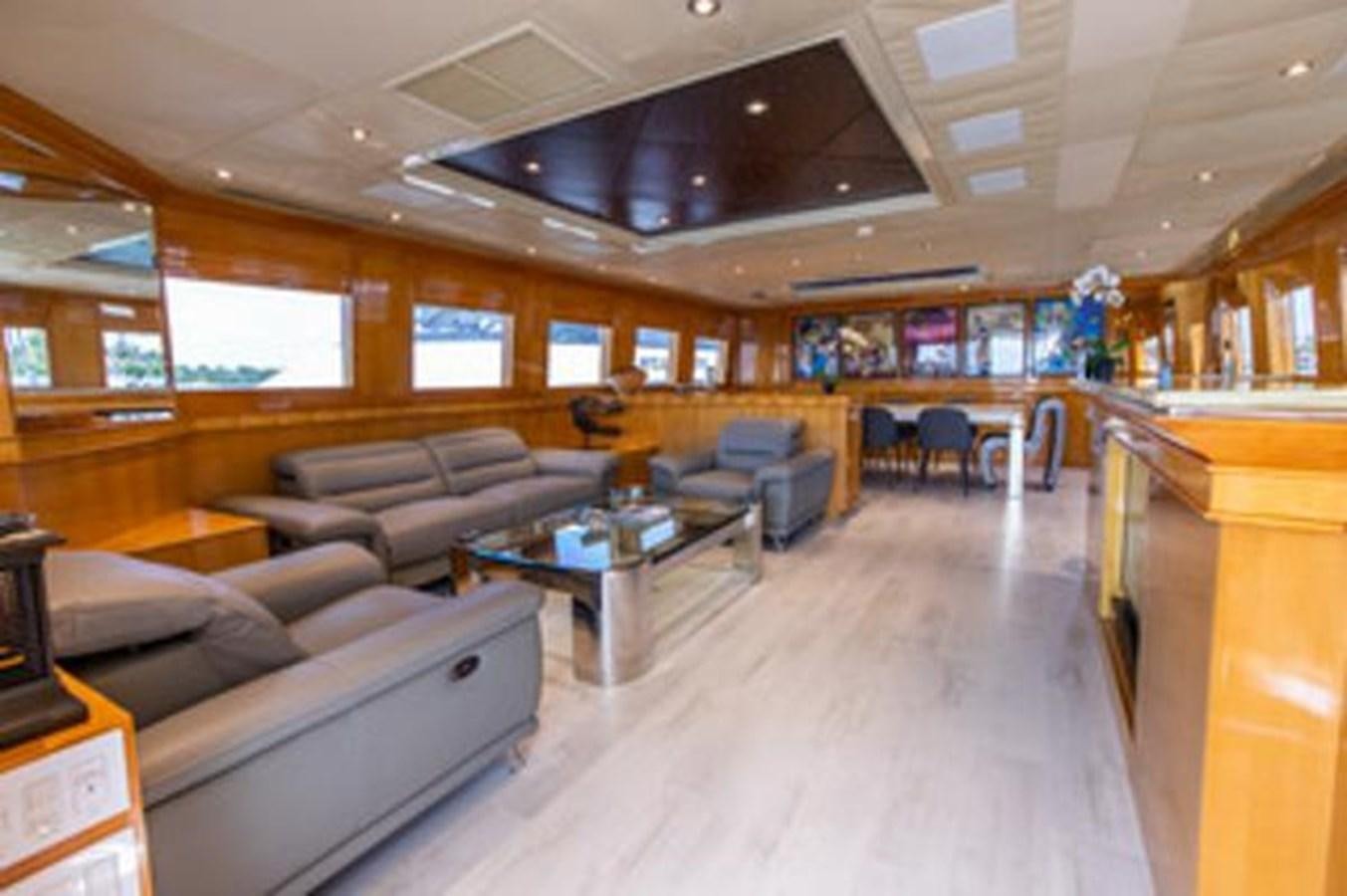 a room with a couch and a table aboard 2000 116 BAGLIETTO Yacht for Sale