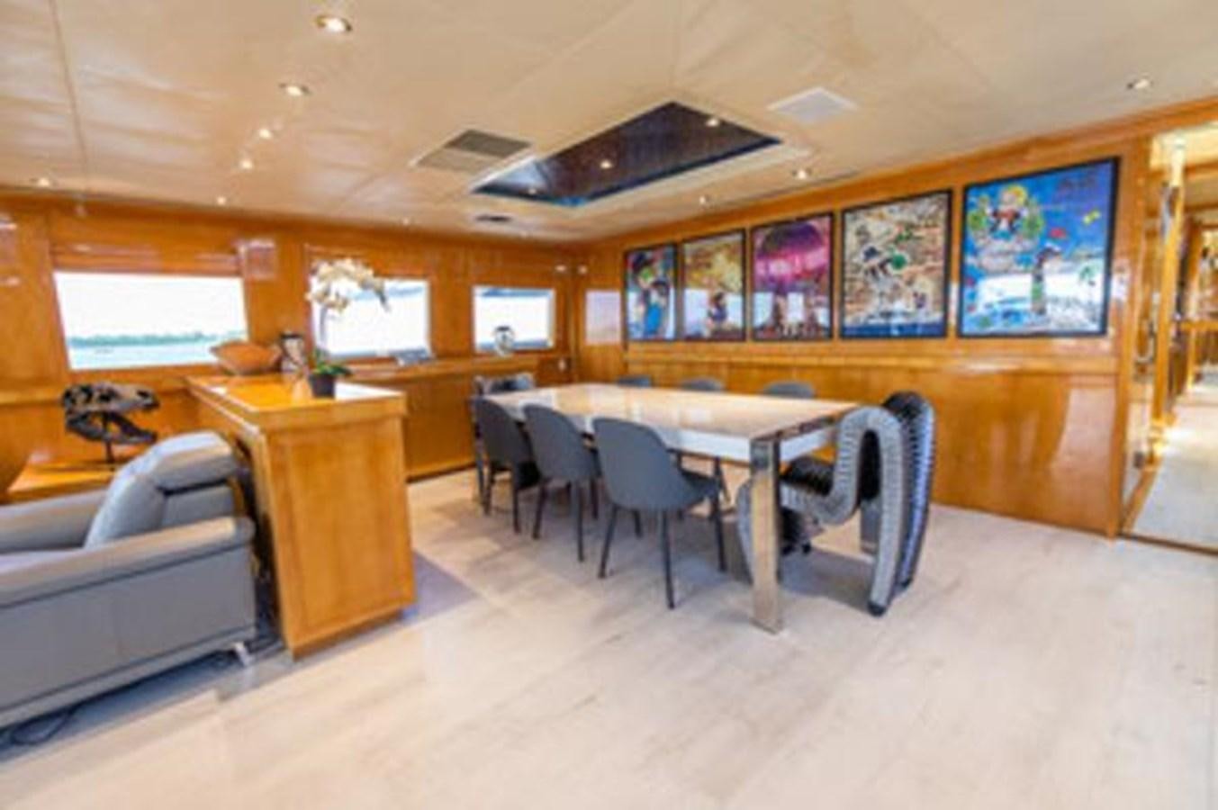 a room with a couch and a table and chairs aboard 2000 116 BAGLIETTO Yacht for Sale