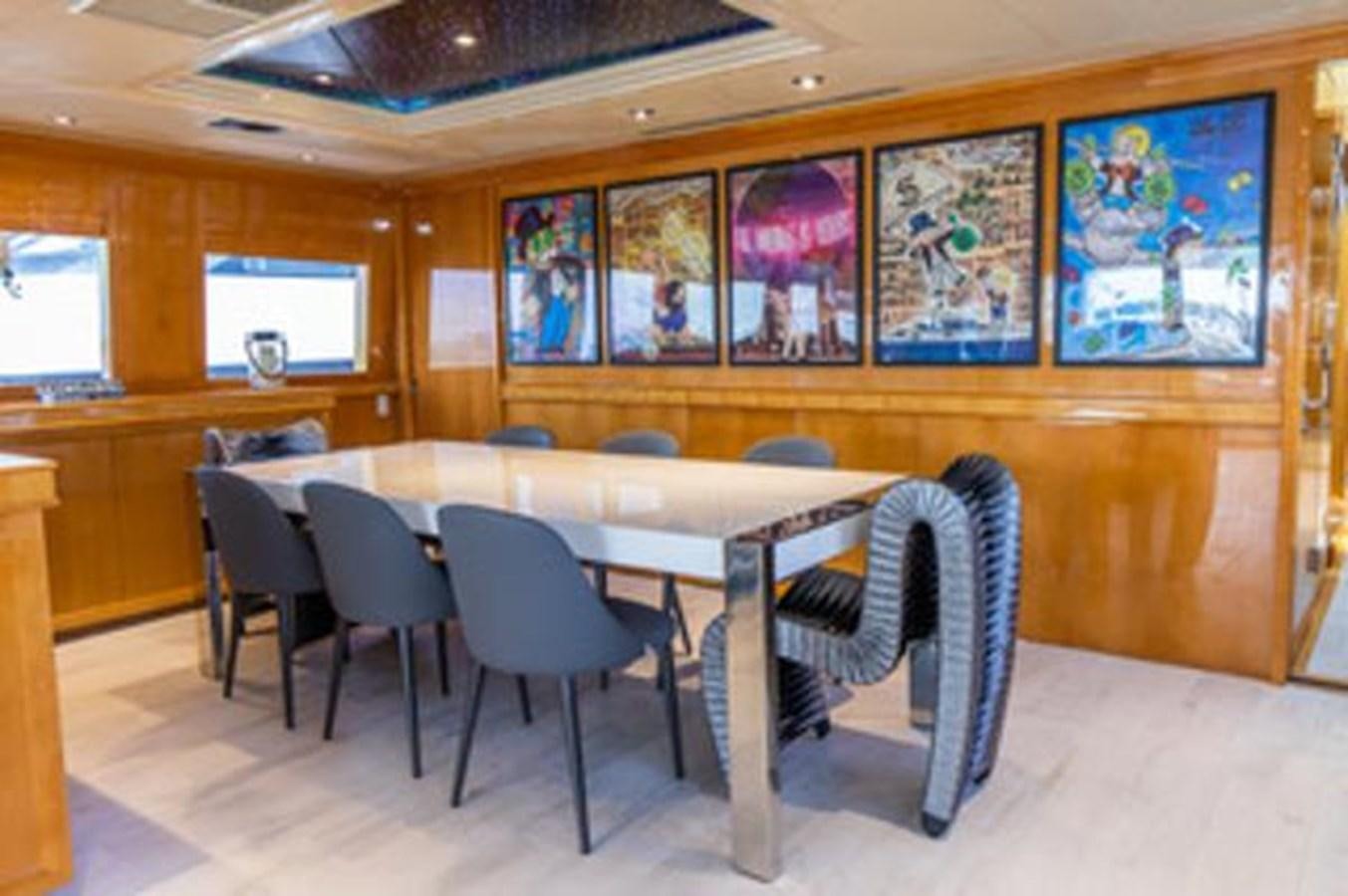 a room with tables and chairs aboard 2000 116 BAGLIETTO Yacht for Sale