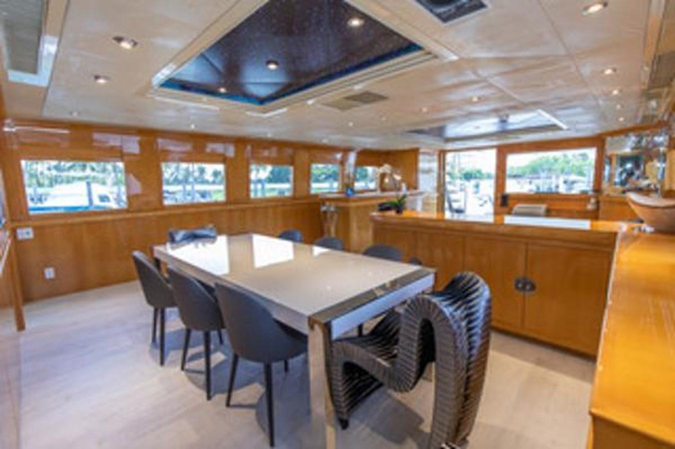 a room with a table and chairs aboard 2000 116 BAGLIETTO Yacht for Sale