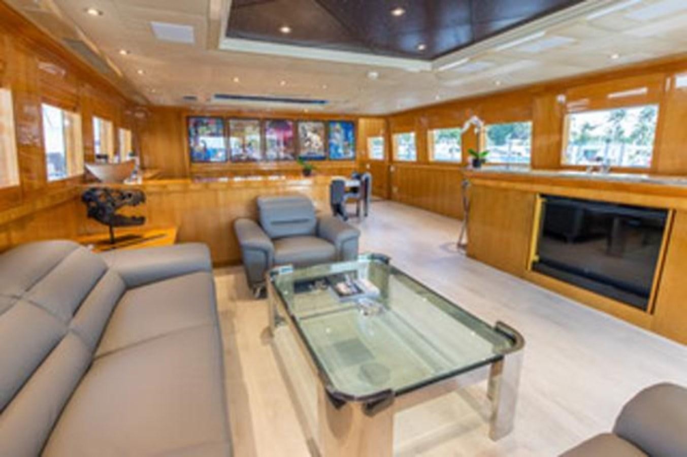a living room with a fireplace aboard 2000 116 BAGLIETTO Yacht for Sale