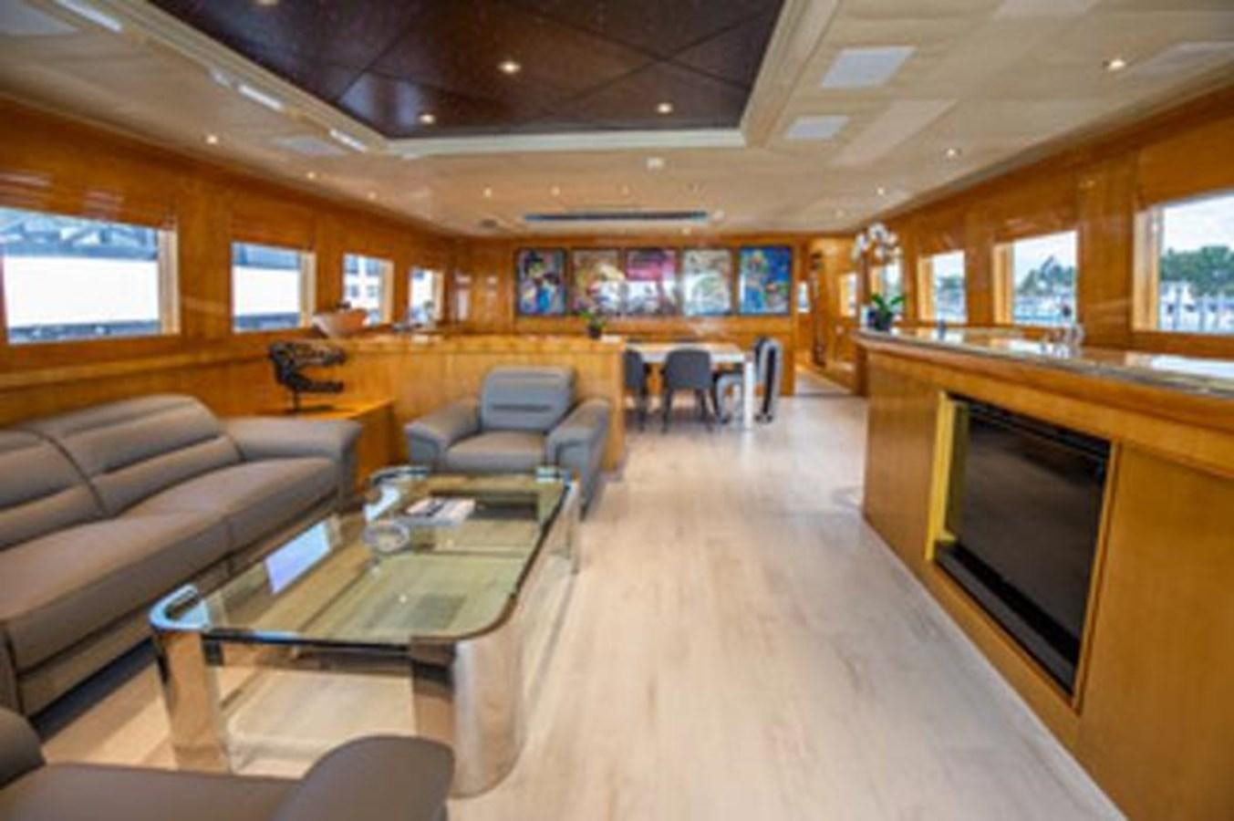 a living room with a large screen aboard 2000 116 BAGLIETTO Yacht for Sale