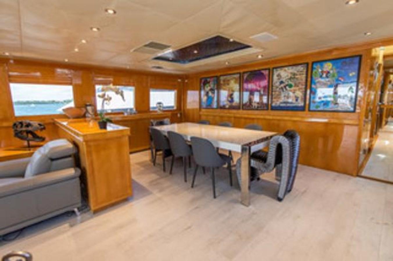 a room with a couch and a table and chairs aboard 2000 116 BAGLIETTO Yacht for Sale