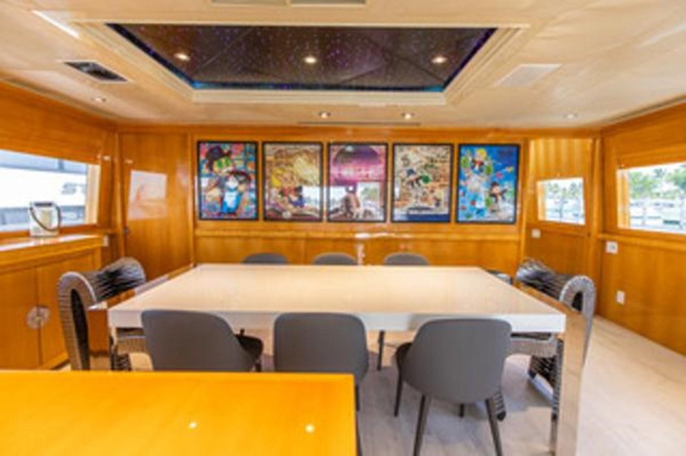 a room with chairs and tables aboard 2000 116 BAGLIETTO Yacht for Sale