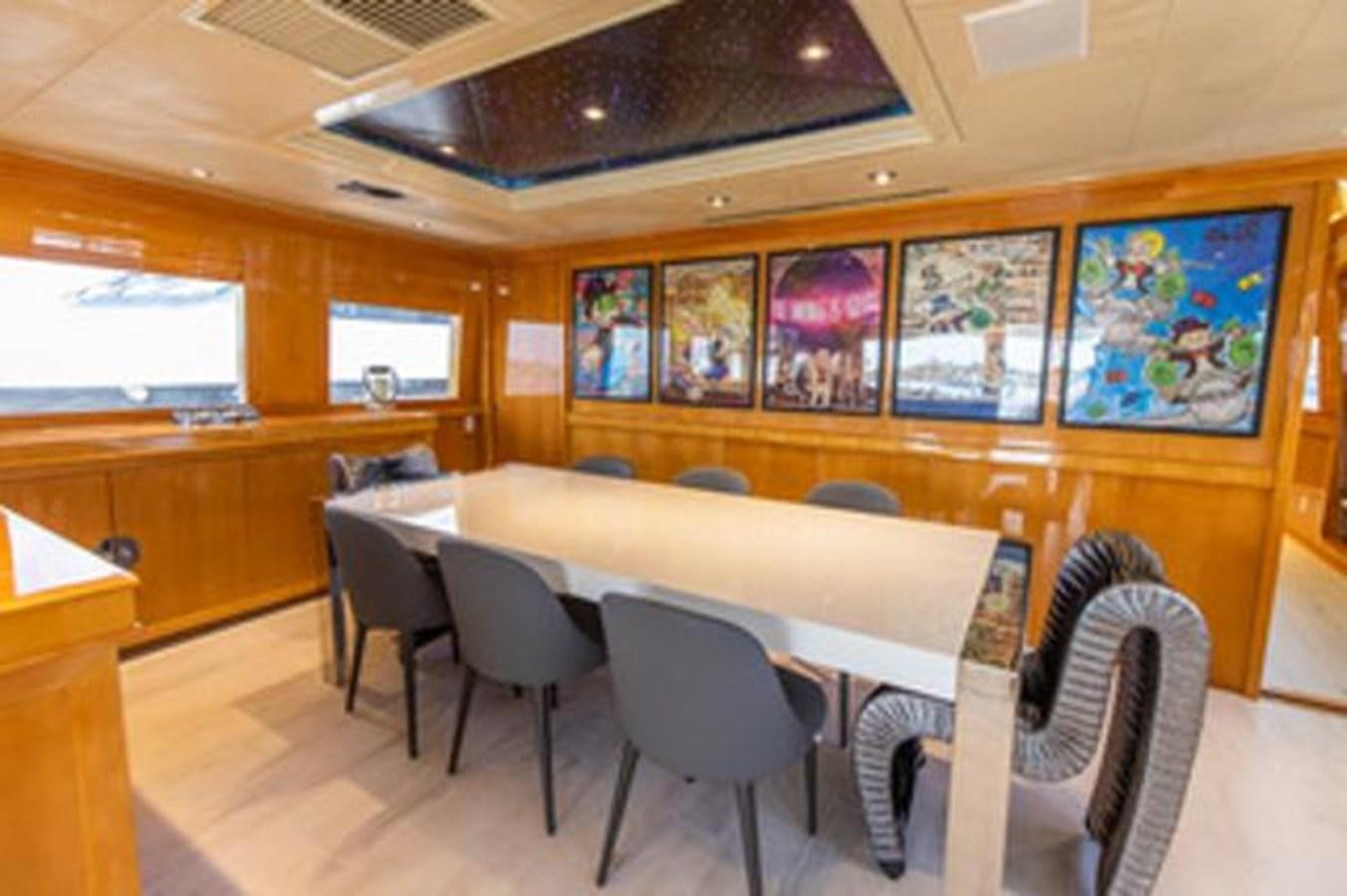 a room with tables and chairs aboard 2000 116 BAGLIETTO Yacht for Sale