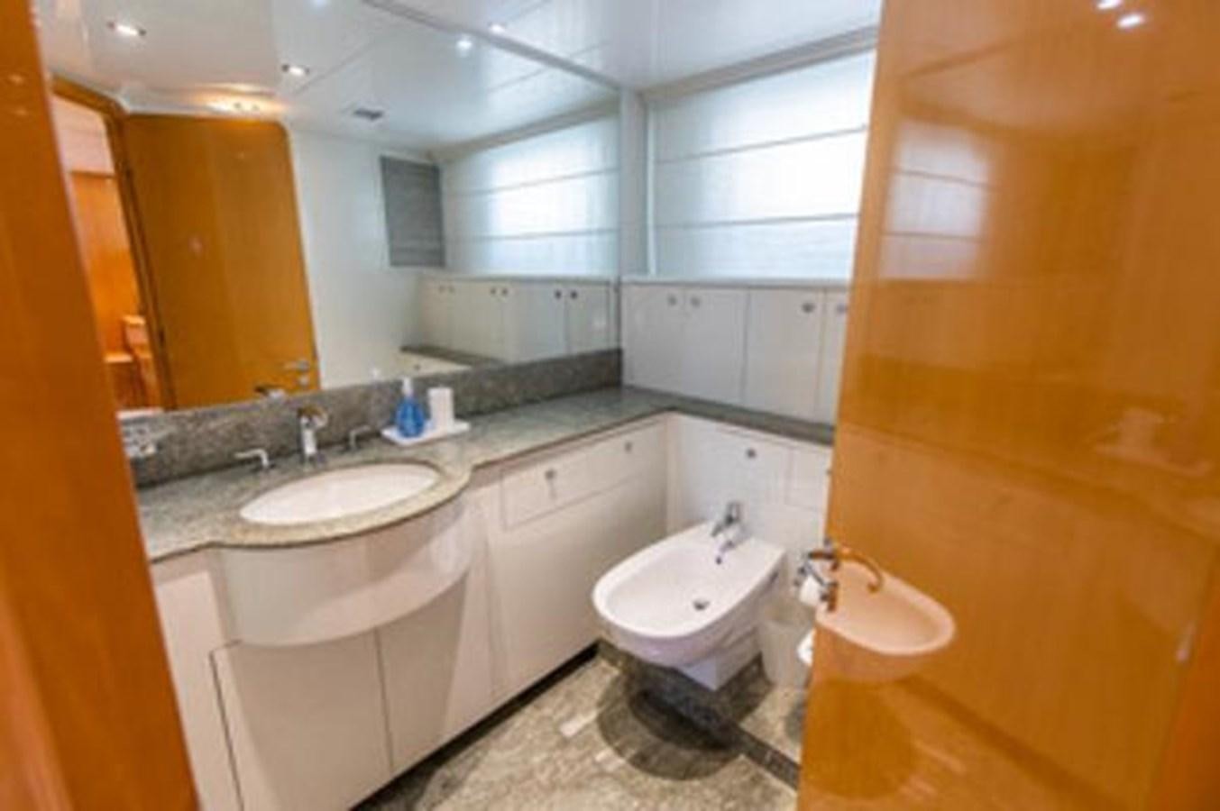 a bathroom with two sinks and a large mirror aboard 2000 116 BAGLIETTO Yacht for Sale