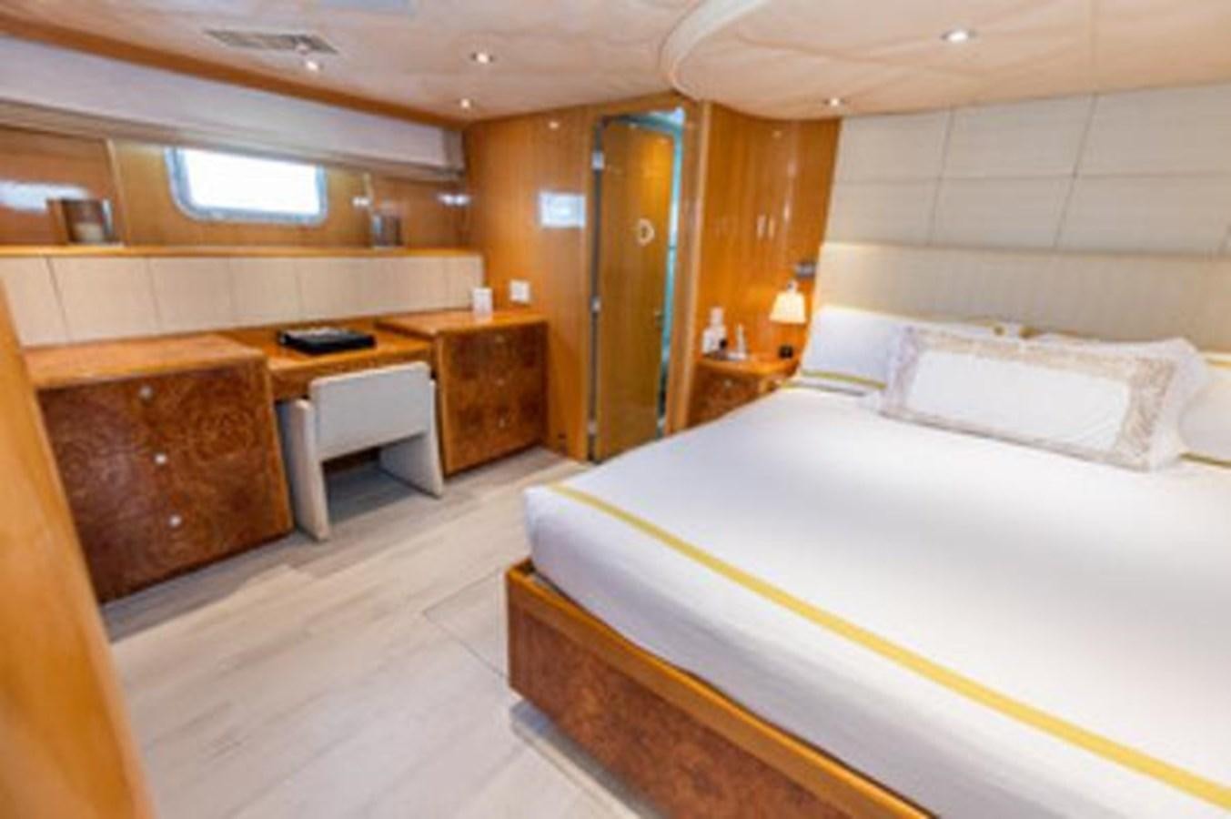 a room with a bed and desk aboard 2000 116 BAGLIETTO Yacht for Sale