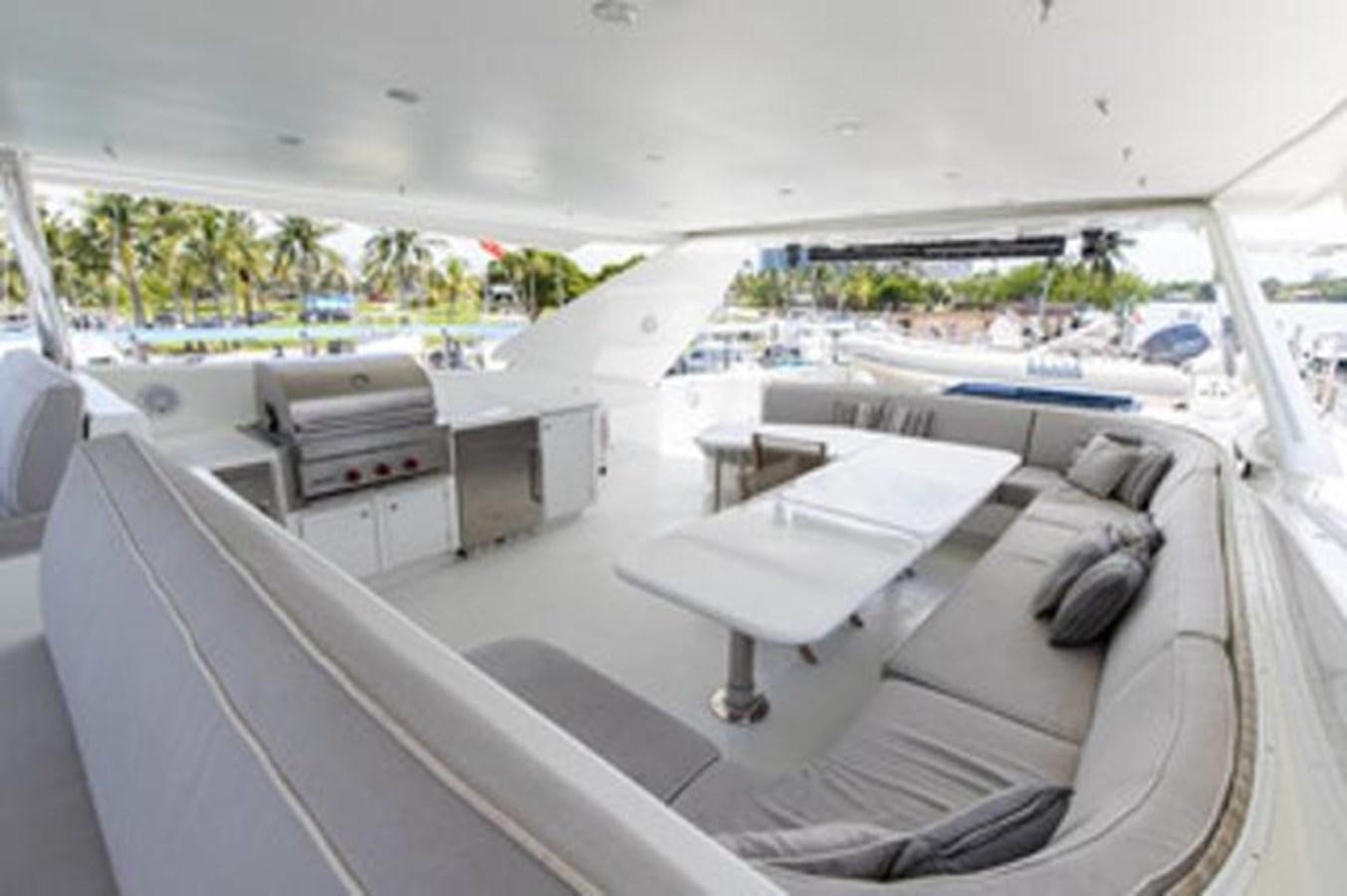 a room with a bed and a desk with a chair and a table aboard 2000 116 BAGLIETTO Yacht for Sale