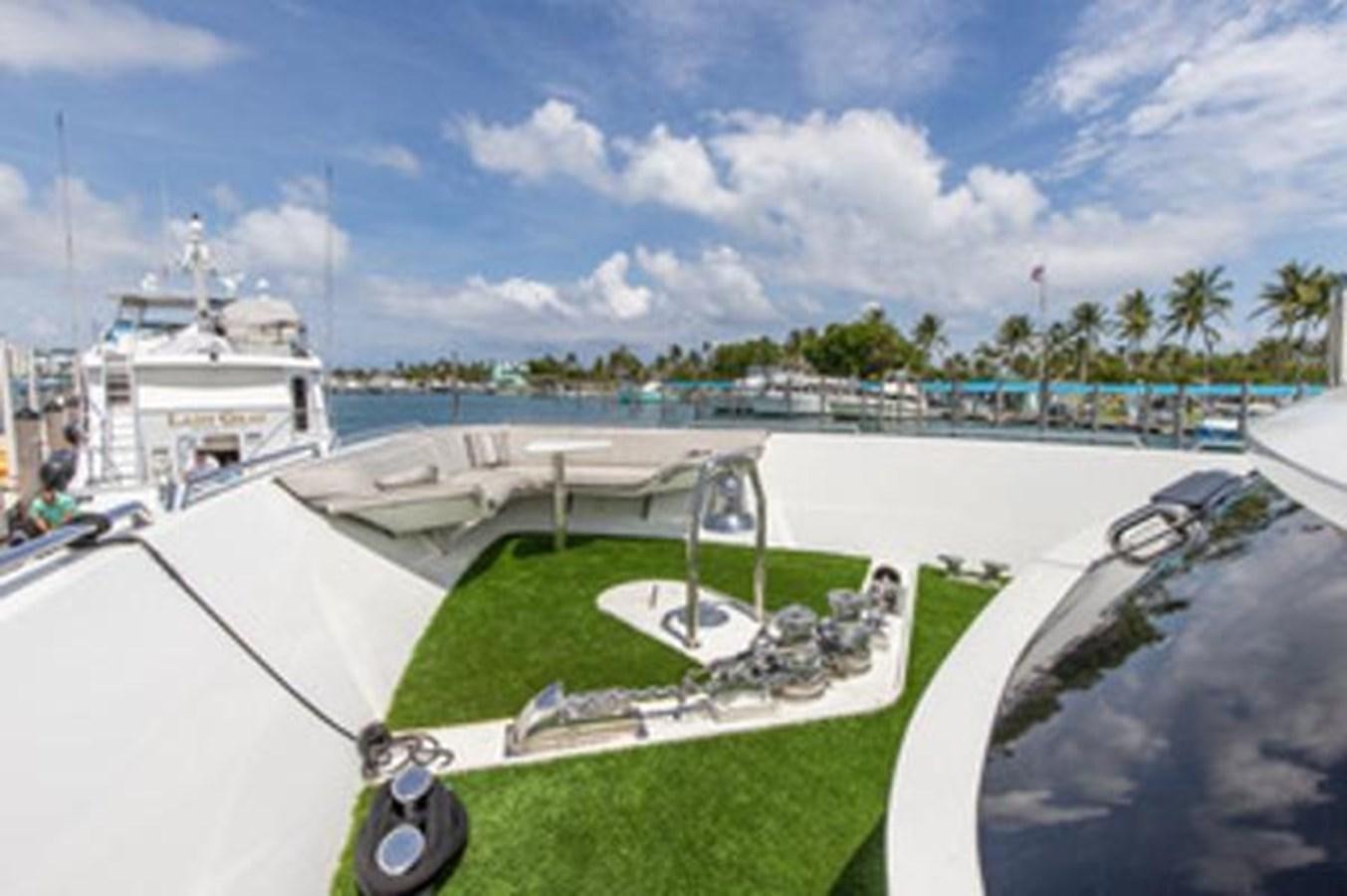 a golf course with a large ship in the background aboard 2000 116 BAGLIETTO Yacht for Sale