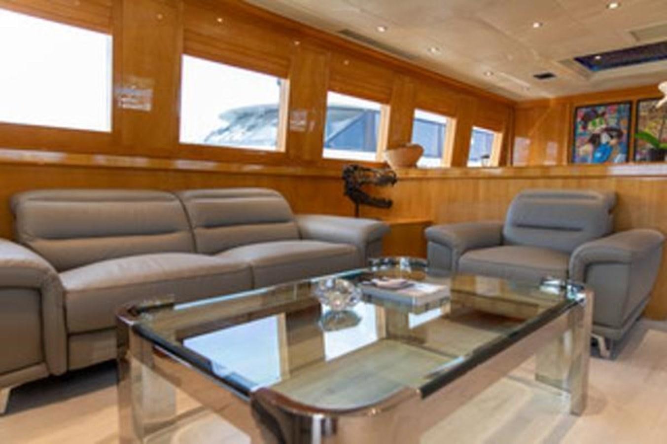 a living room with leather couches aboard 2000 116 BAGLIETTO Yacht for Sale
