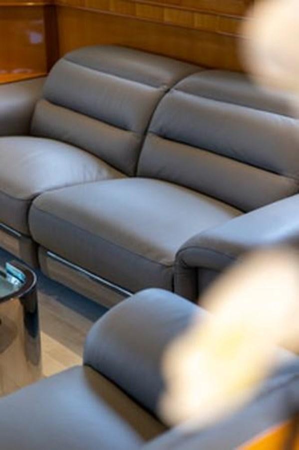 a couch with a chair in the background aboard 2000 116 BAGLIETTO Yacht for Sale