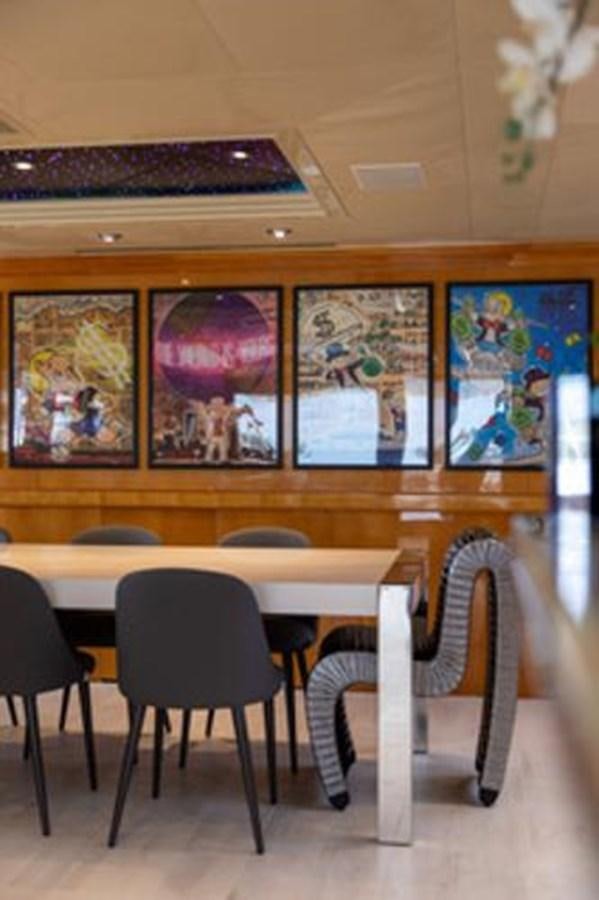 a room with a table and chairs aboard 2000 116 BAGLIETTO Yacht for Sale