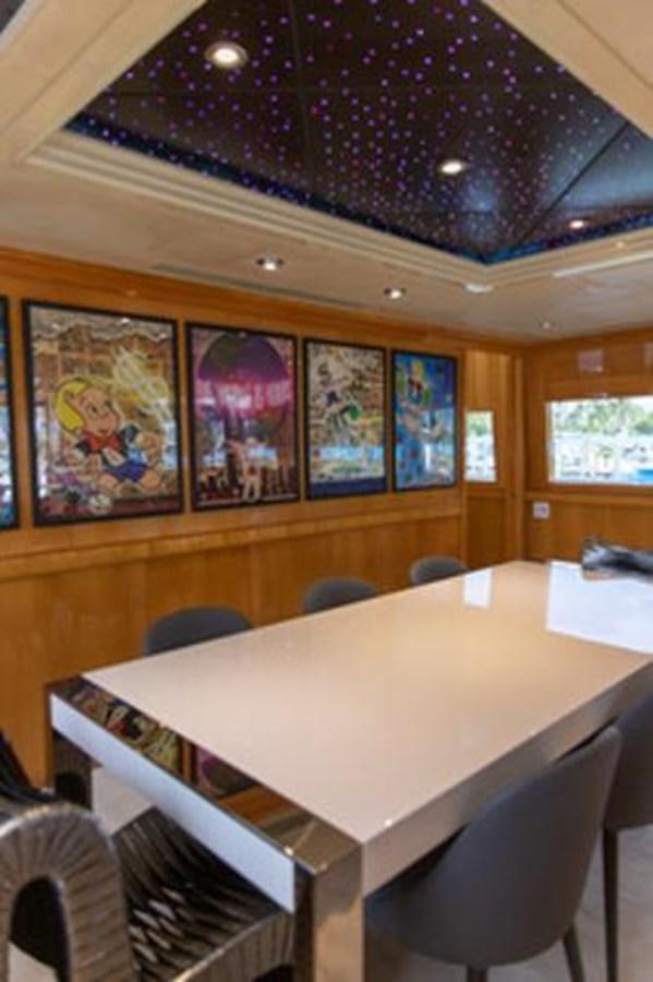 a room with a table and chairs aboard 2000 116 BAGLIETTO Yacht for Sale