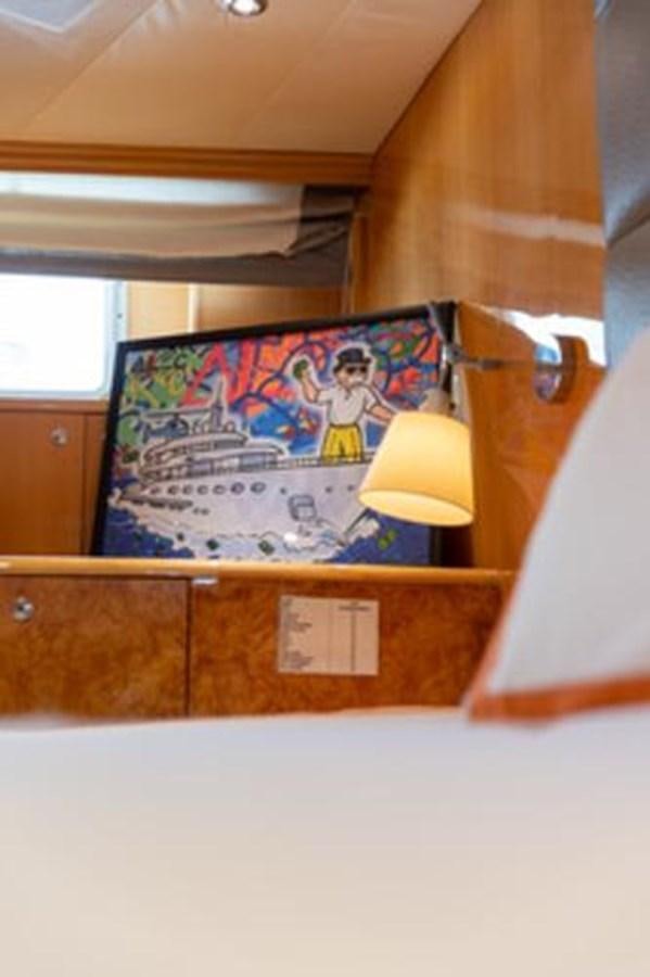 a room with a painting on the wall aboard 2000 116 BAGLIETTO Yacht for Sale