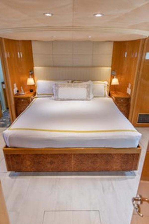 a bed with white sheets aboard 2000 116 BAGLIETTO Yacht for Sale