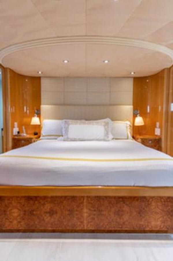 a bed with white sheets aboard 2000 116 BAGLIETTO Yacht for Sale