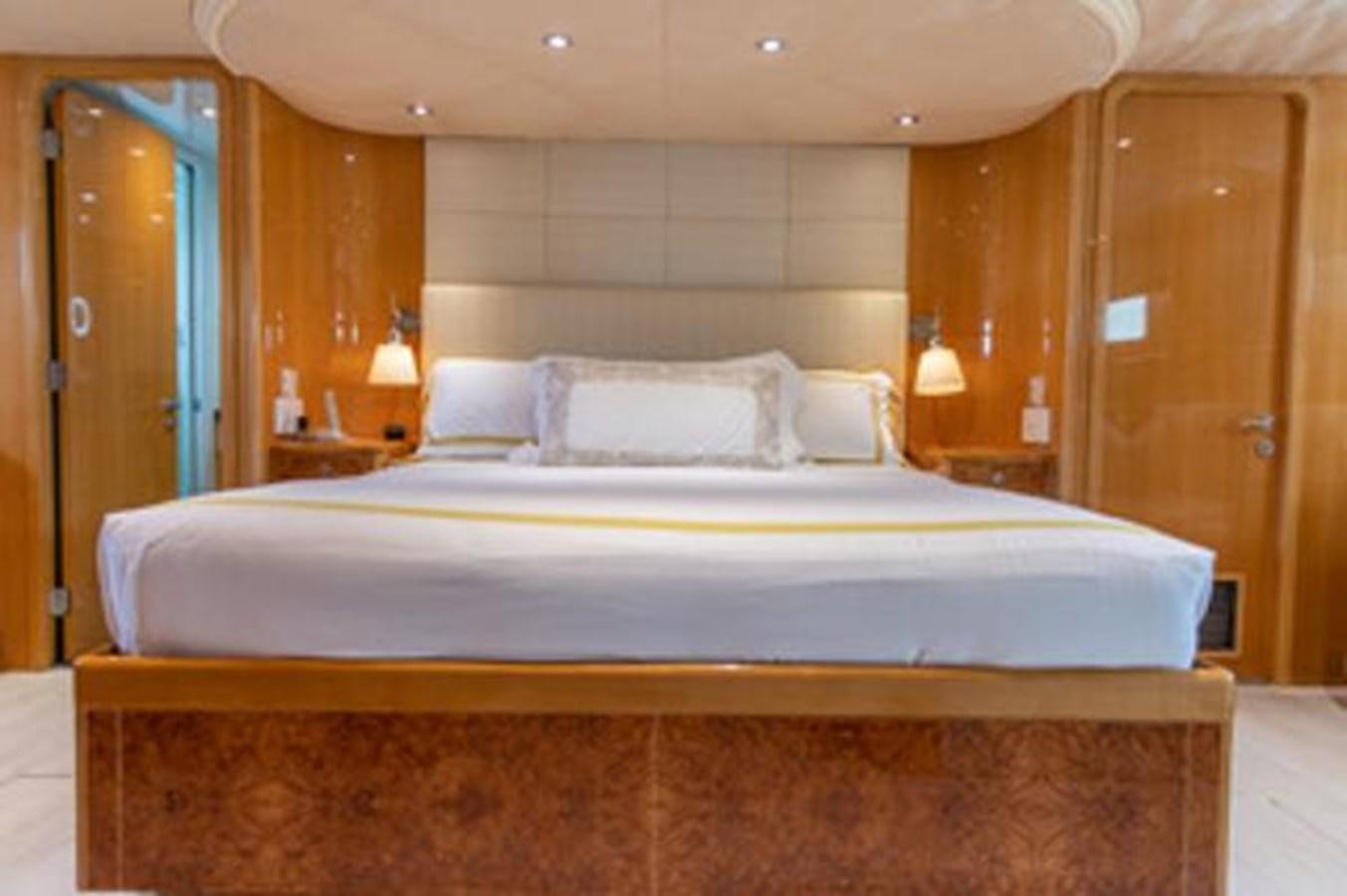 a bed with white sheets aboard 2000 116 BAGLIETTO Yacht for Sale