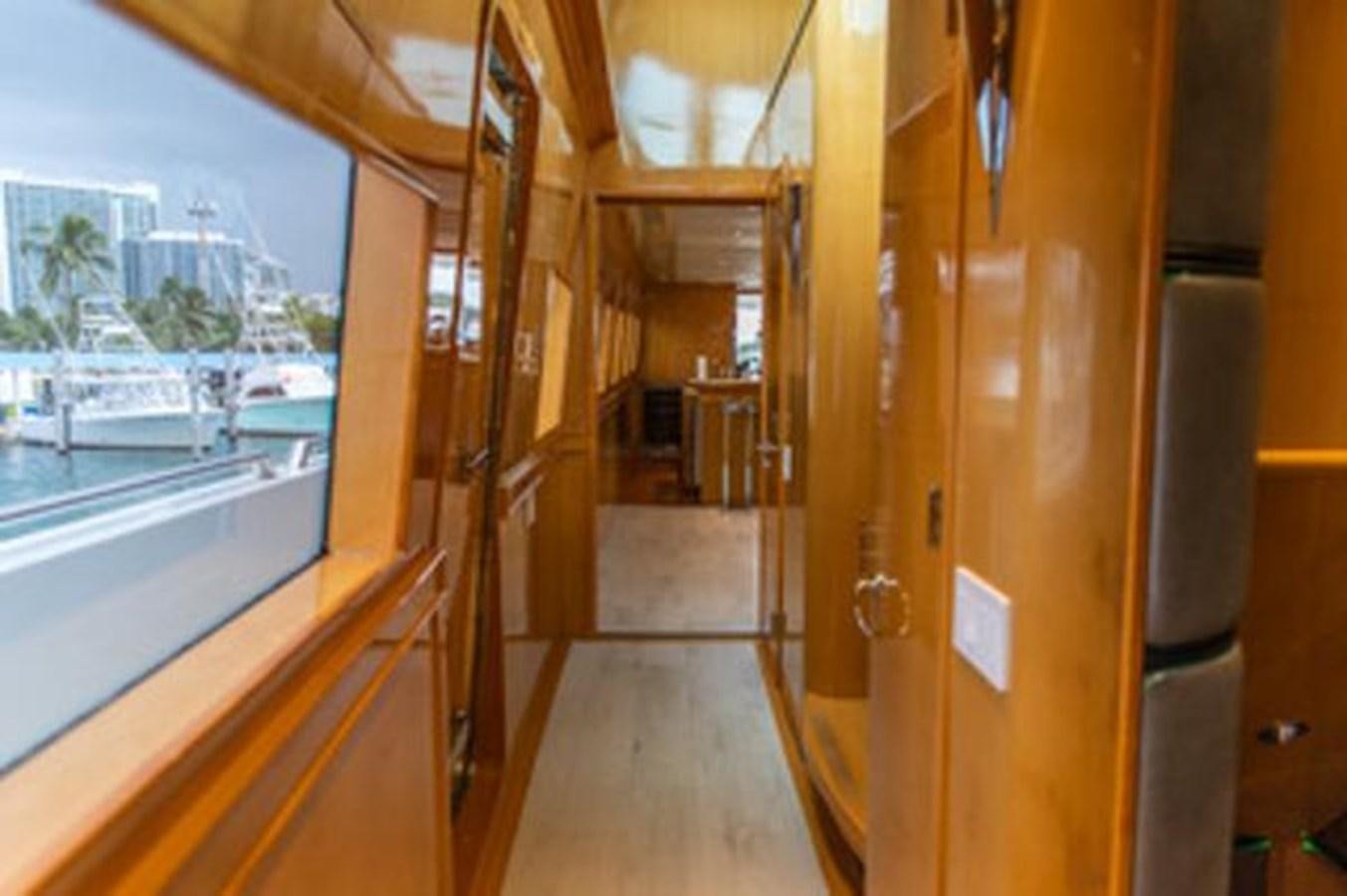 a hallway with glass doors aboard 2000 116 BAGLIETTO Yacht for Sale