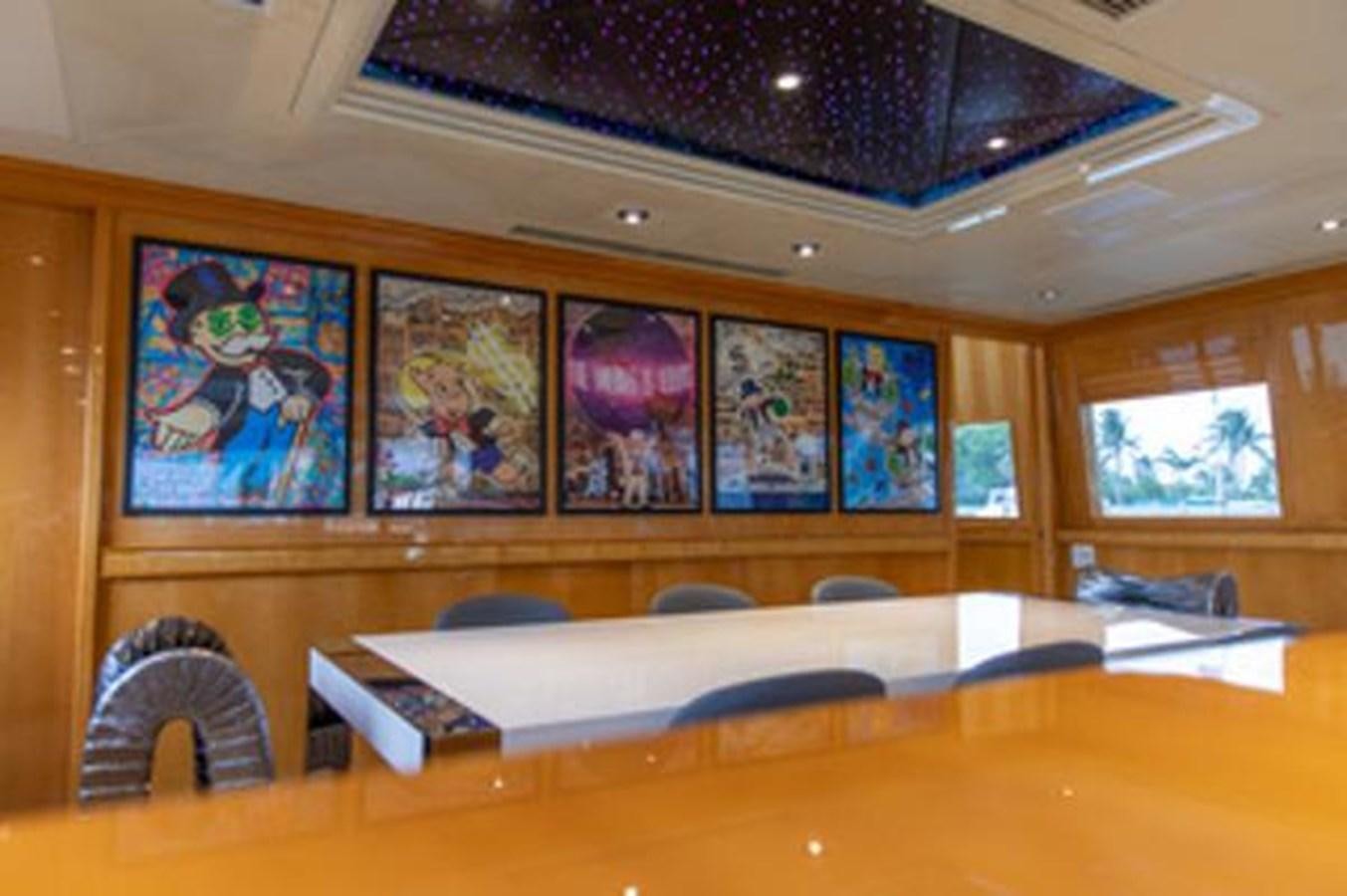 a room with a large painting on the wall aboard 2000 116 BAGLIETTO Yacht for Sale