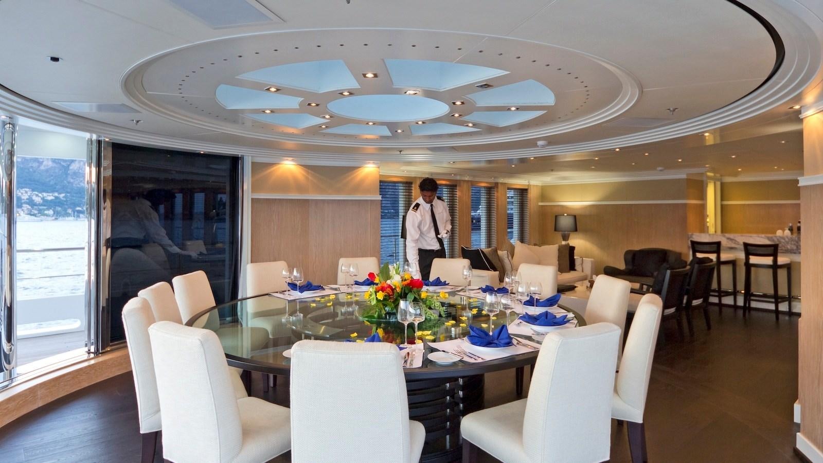 a person standing in a room with tables and chairs aboard BELLA 2 Yacht for Sale