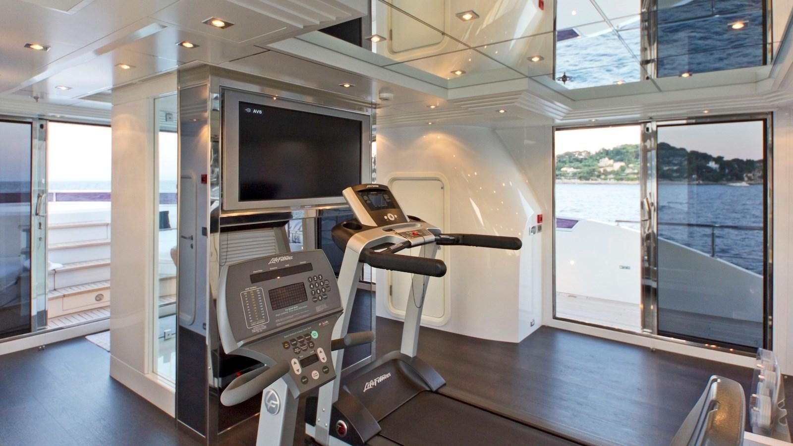 a room with a large window and a tv on the wall aboard BELLA 2 Yacht for Sale