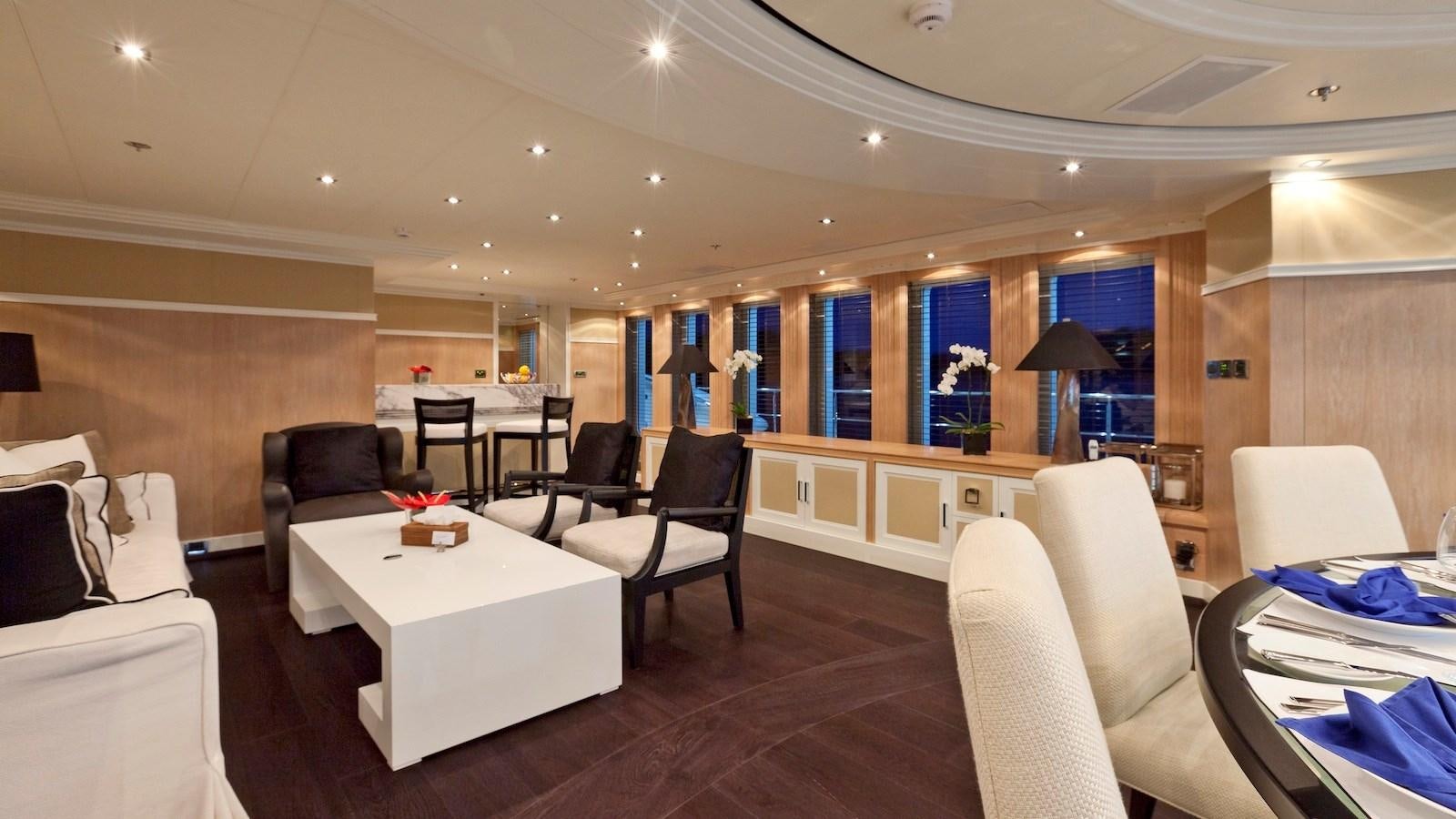a living room with a table and chairs aboard BELLA 2 Yacht for Sale